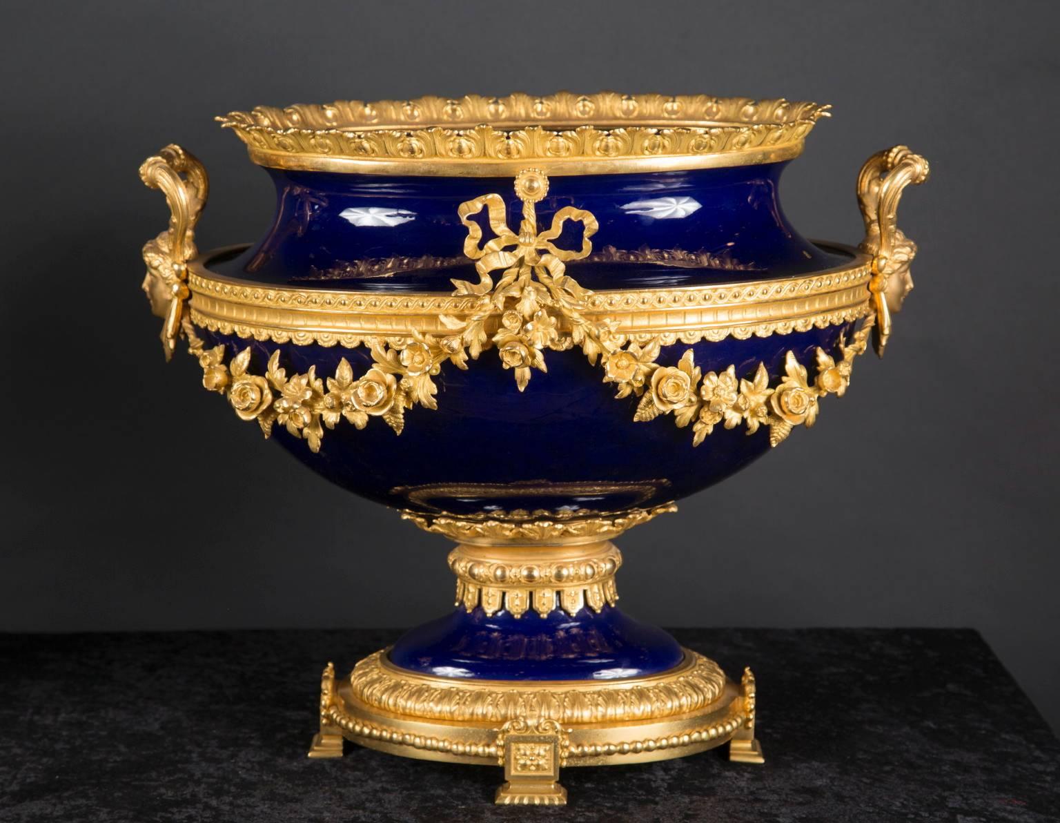 Made in 19th century France, these antique centerpieces are made from exquisitely beautiful cobalt porcelain. This porcelain is an incredible deep, dark blue color. This creates a wonderful contrast to the bronze ornaments on the centerpieces. These