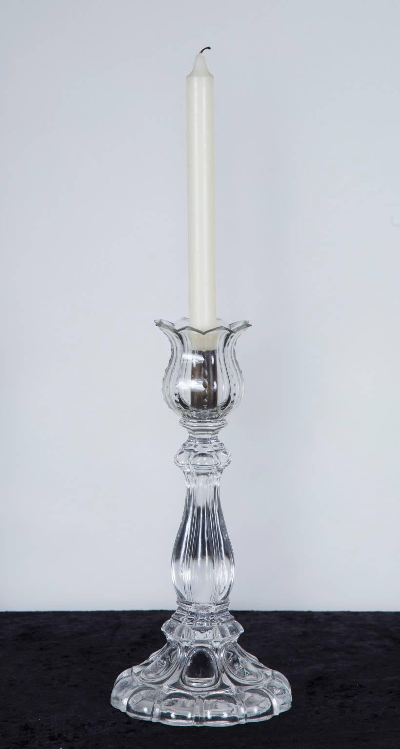 This pair of crystal candlesticks are made of beautiful St. Louis crystal, with a mark on the bottom. The top of each candlestick is shaped resembling a tulip. A beautiful addition to any tabletop, watch the crystal sparkle in the candlelight in