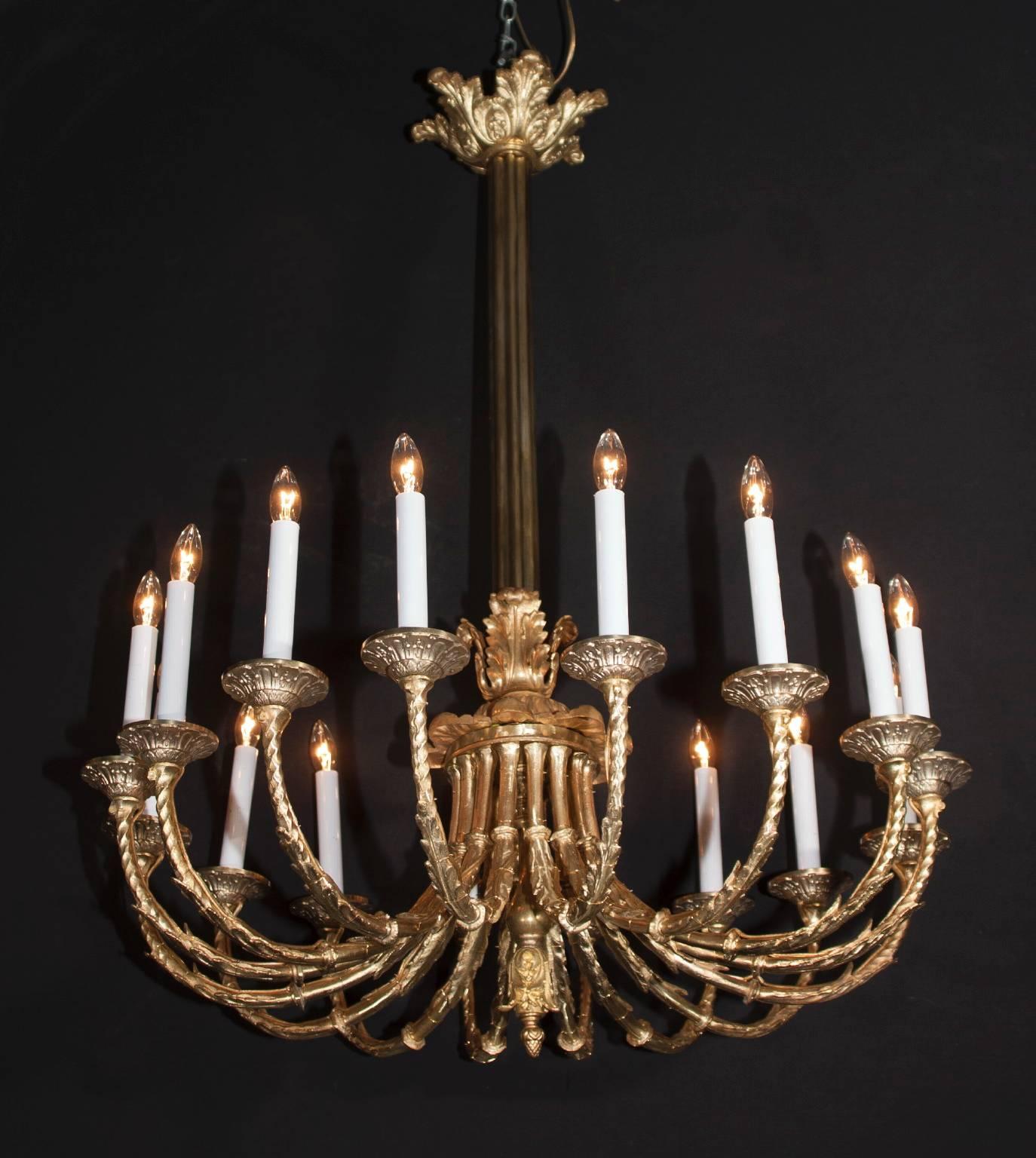 This classic Belle Époque chandelier is made of bronze and features an impressive 16 burnished bronze arms. The French antique fixture dates back to the late 19th century and plays host to a beautiful and simple acanthus leaf crown at top. The arms