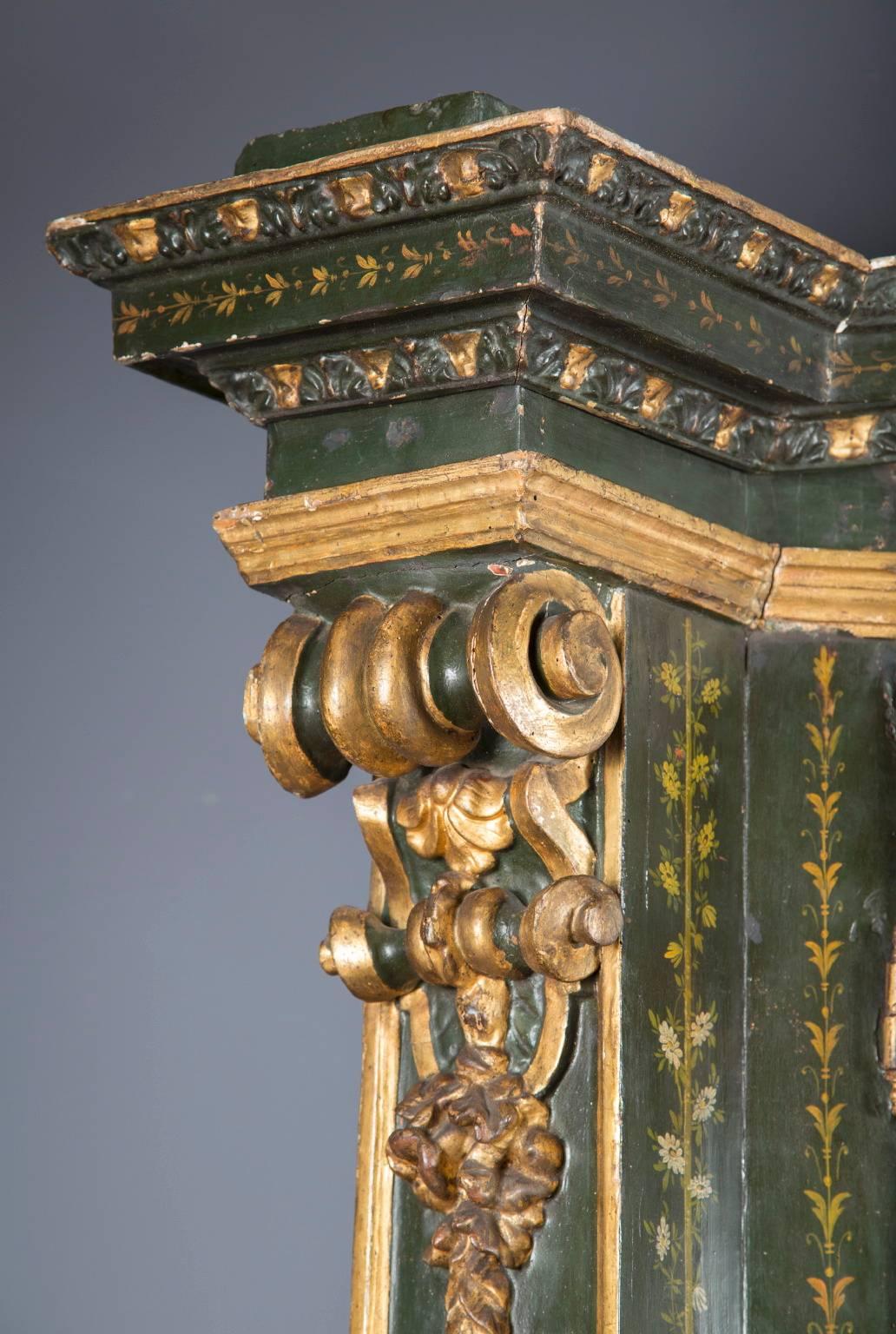 Crafted in the 18th century, this antique Austrian two door cabinet is painted with a well-detailed floral motif and adorned with hand-carved and gold leafed decorations. Exquisitely enough, all the original glass is still on the piece, a rarity