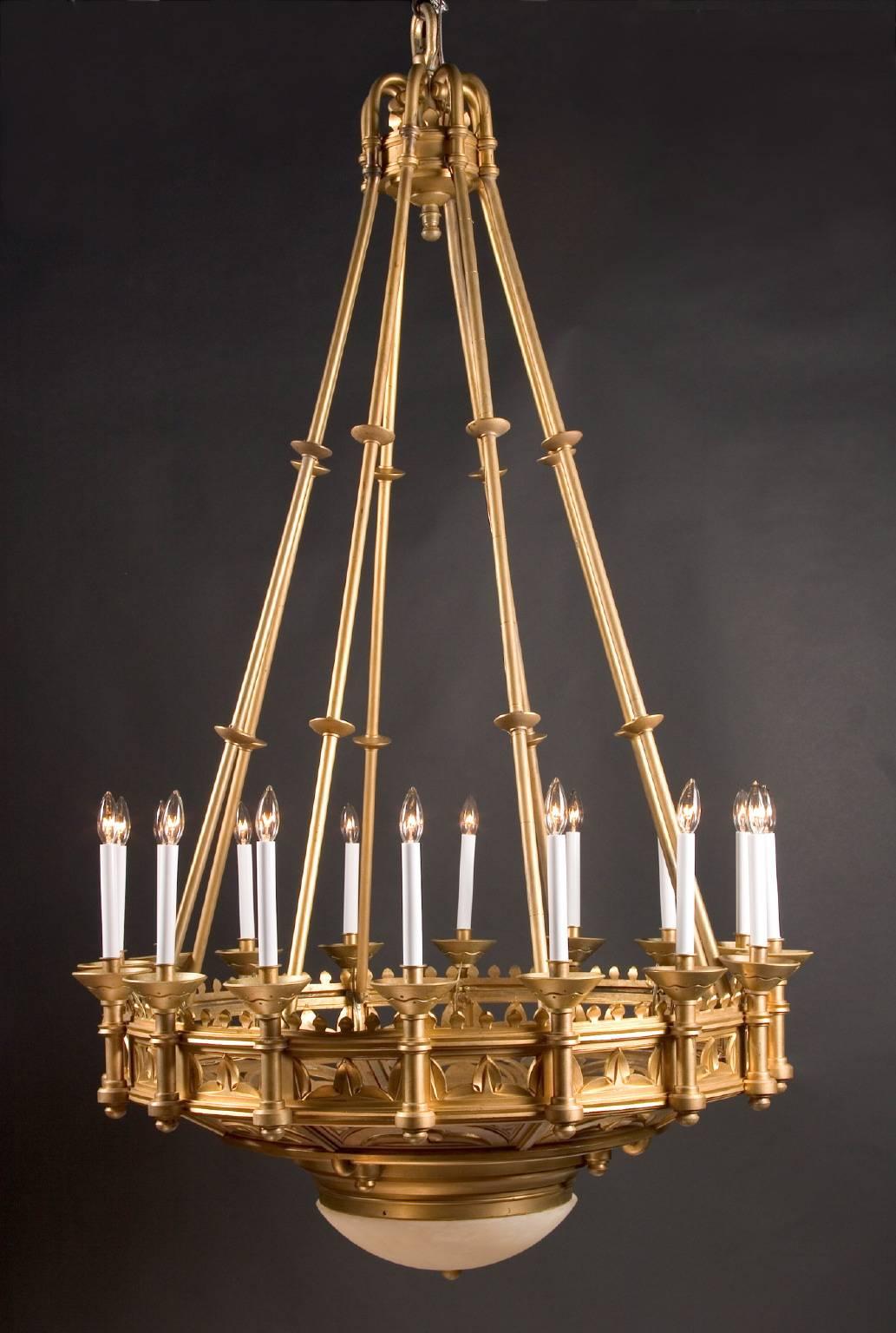 Originally made for gas, this antique gasolier creates a striking visual presence with the simple-yet-elegant designs cut into the bronze. Note the pattern cut into the base of the bobeches. The chandelier is made of solid bronze, with bronze tubes