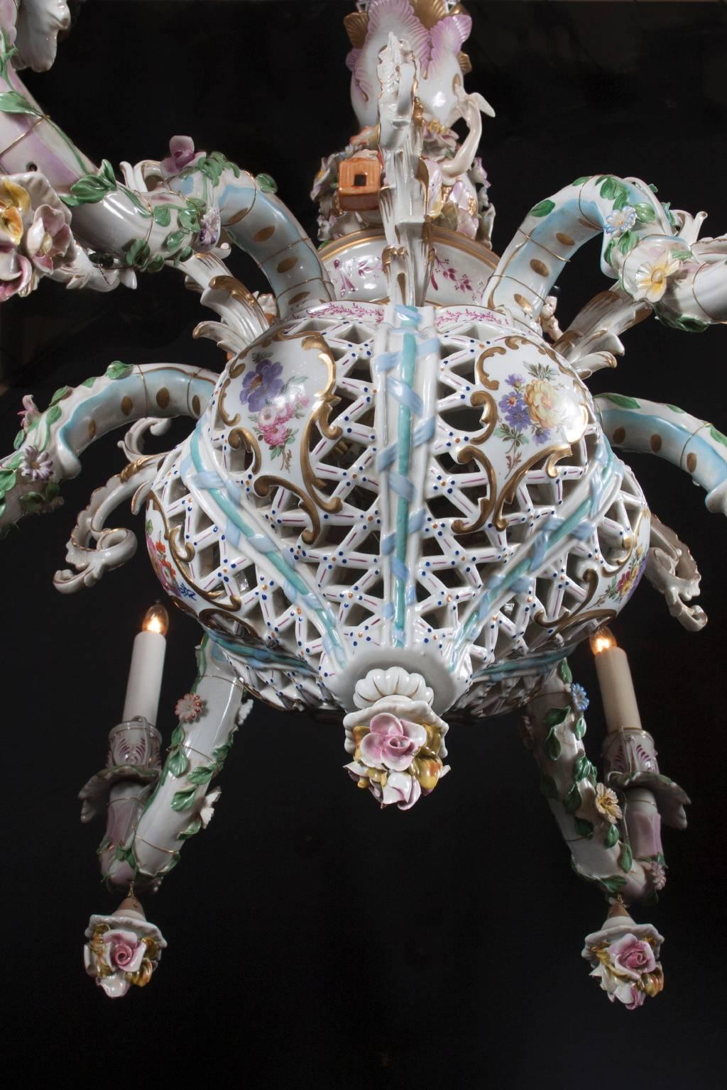 This beautiful chandelier is perfectly complemented by the matching pair of wall sconces. All three are Capodimonte porcelain, a style that directly emulated the German Meissen porcelain. Capodimonte is known for molded figurines and decorative