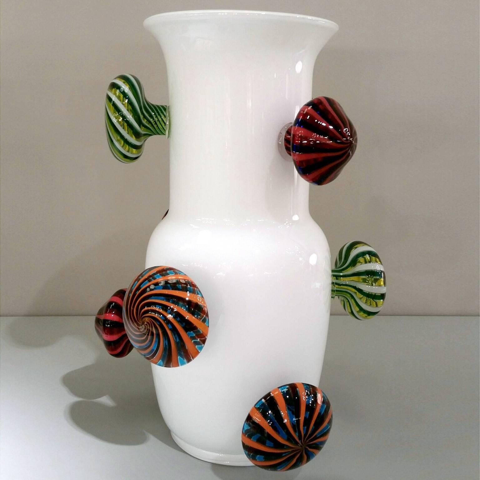 The project represent an interpretation by Alberto Biagetti of one of the most famous Venini vase: "Opalino";. Decorations with glass canes are applied while the glass is still hot.
Color: white opaline vase with multicolor