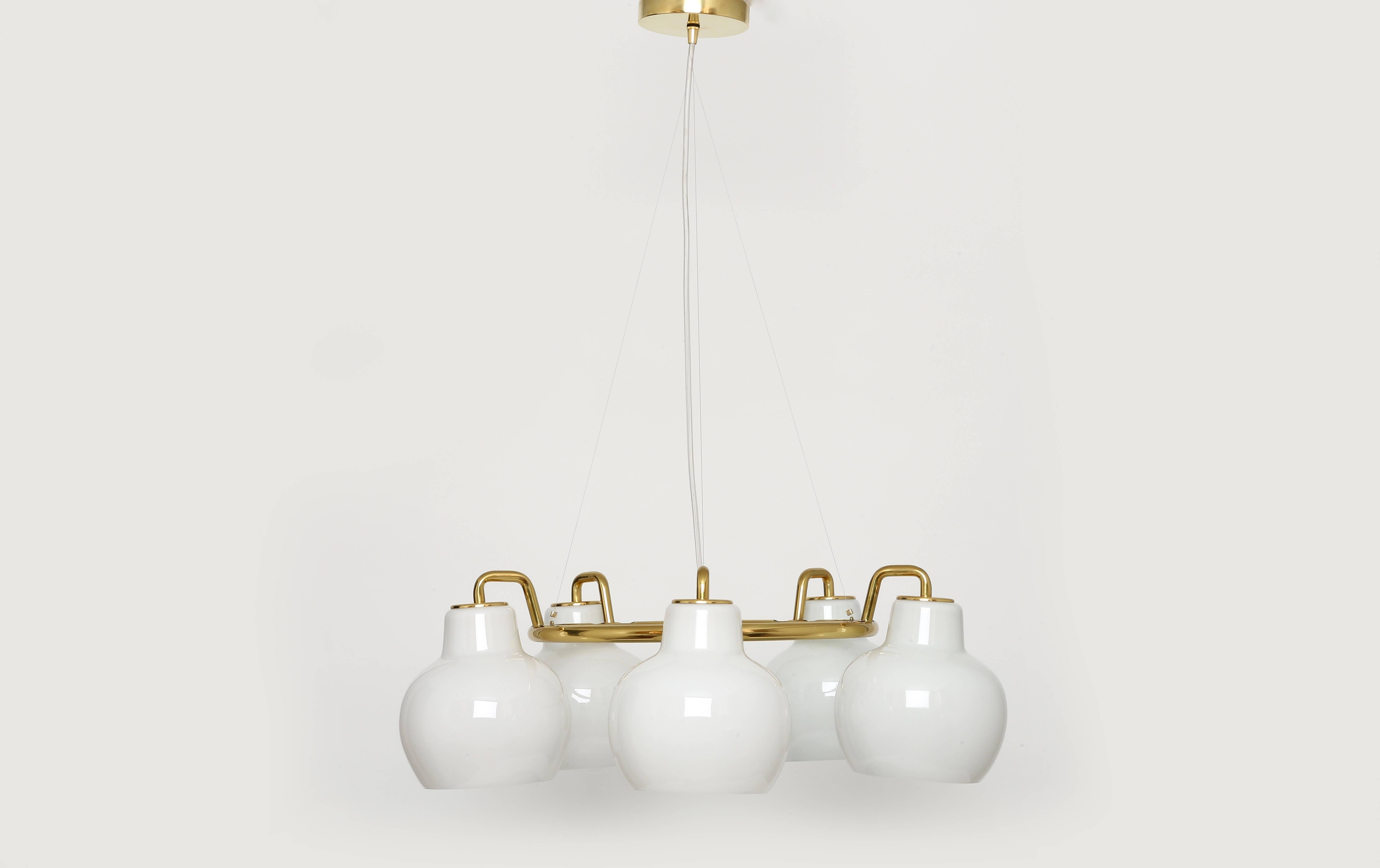 "Christiansborg" chandelier designed by Danish architect Vilhelm Lauritzen for Louis Poulsen.
Five handmade opaline glass bells and a solid brass ring,
Denmark, 1950s.
Two chandeliers available.

Matching wall lamps are available as