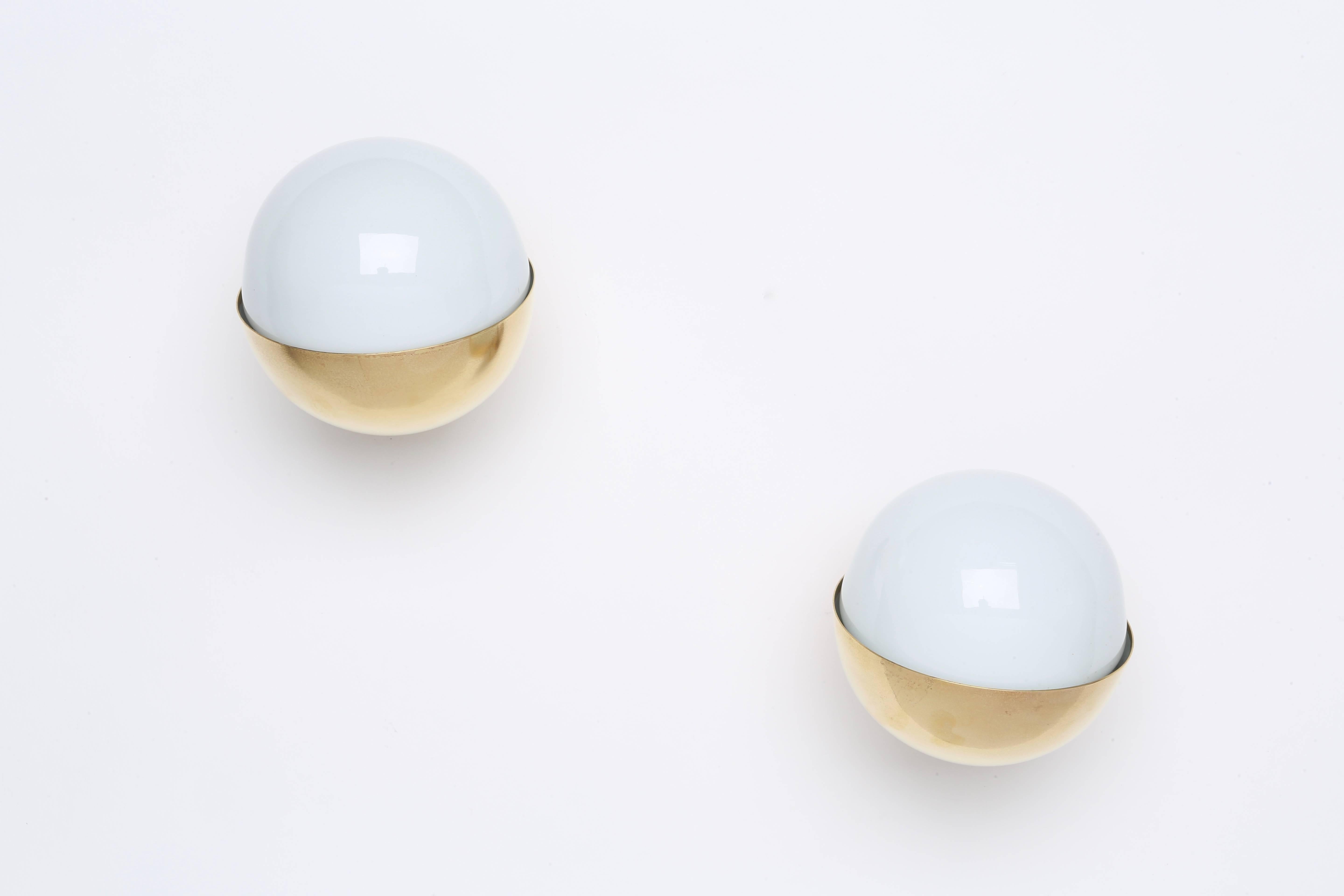 Pair of wall lamps designed by Danish architect Vilhelm Lauritzen for the Broadcasting House in Copenhagen.
Made by Louis Poulsen.
Brass and opaline glass.
 