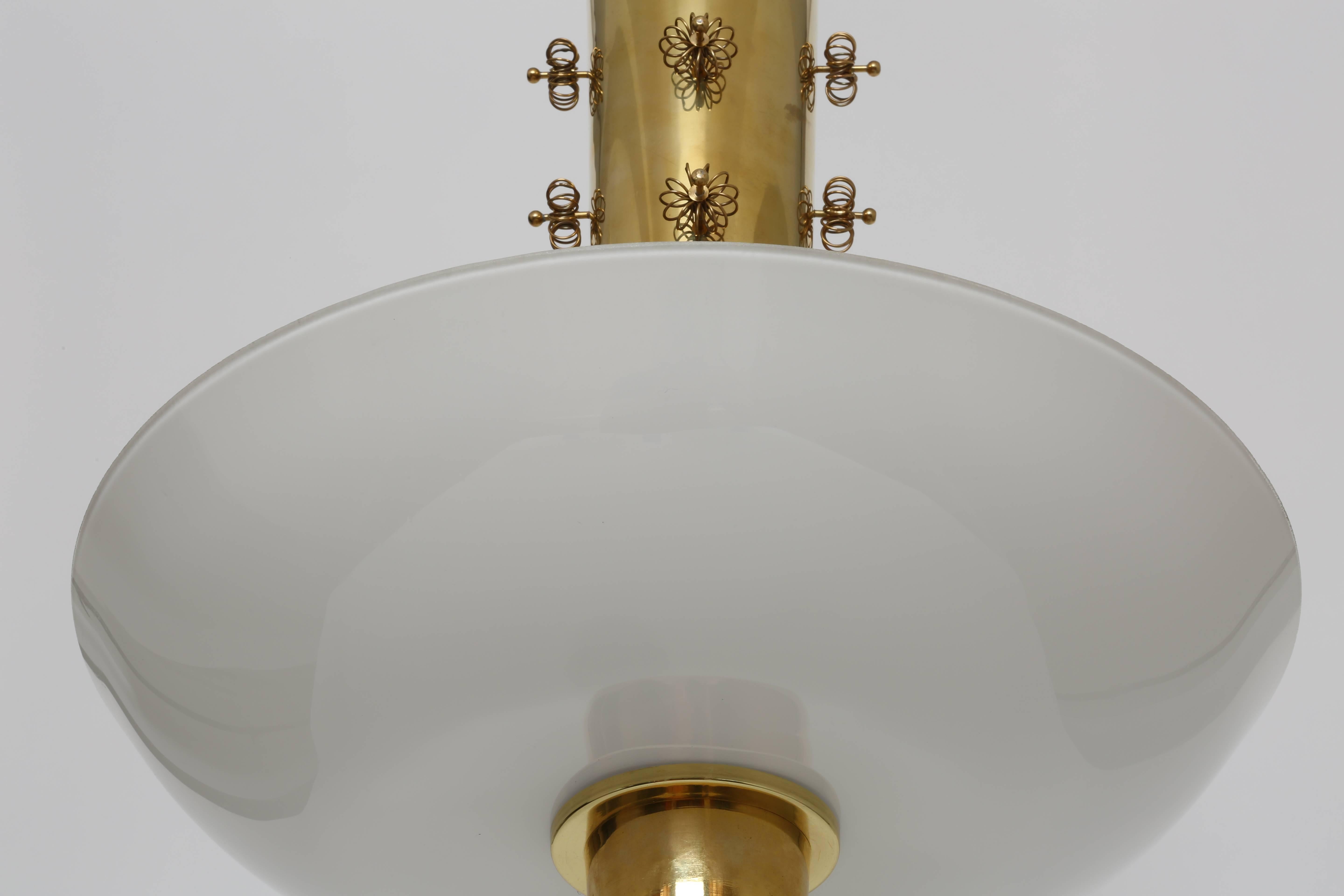 Very elegant ceiling fixture by Paavo Tynell.
Brass and opaline glass with brass flowers on the fixture's stem.
Finland, 1950s.
Marked Taito Oy.

 