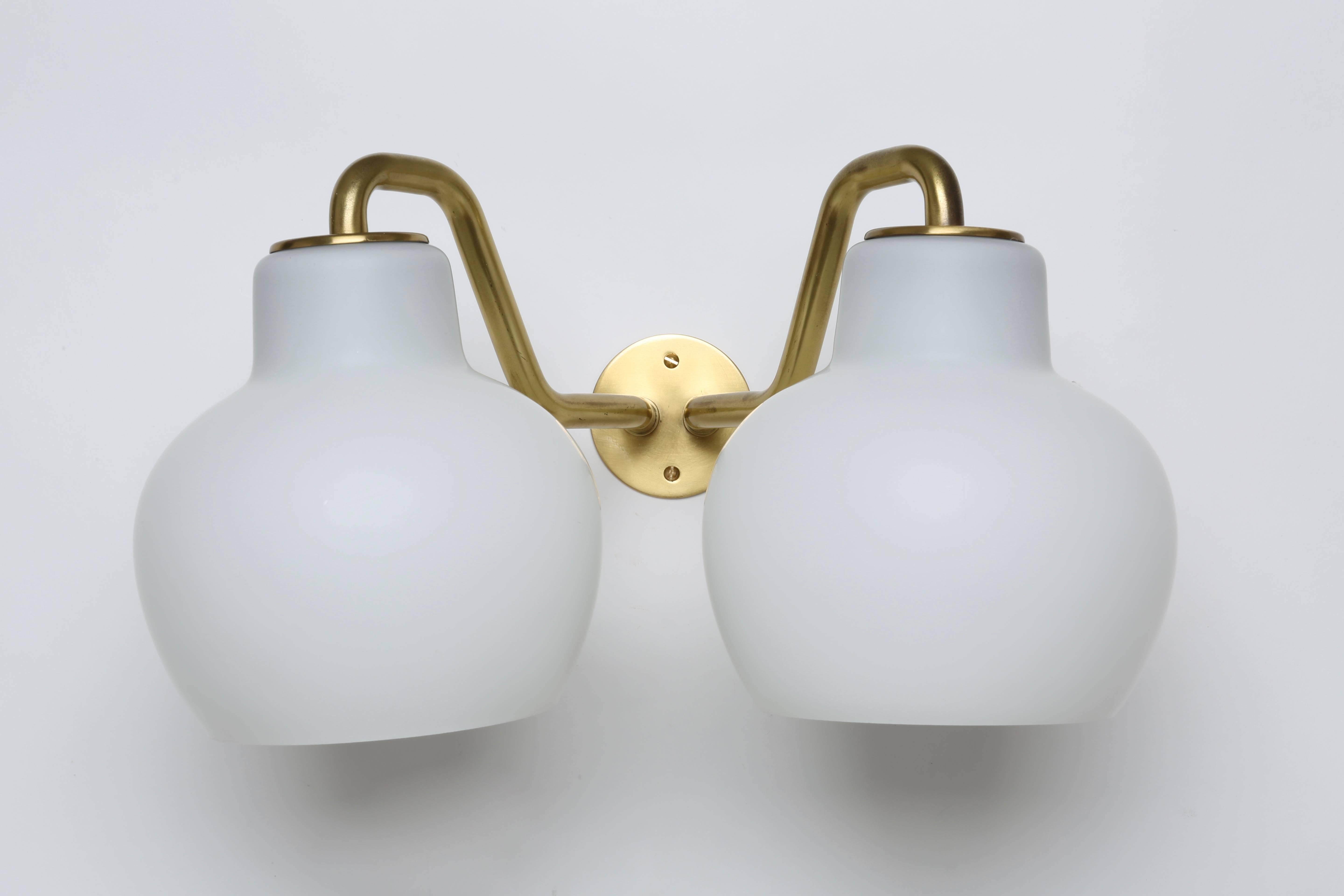 Wall lamps designed by Danish architect Vilhelm Lauritzen for Louis Poulsen.
Made with brass and handblown opaline glass.
Denmark, 1950s.
Priced per item. Three available.

 