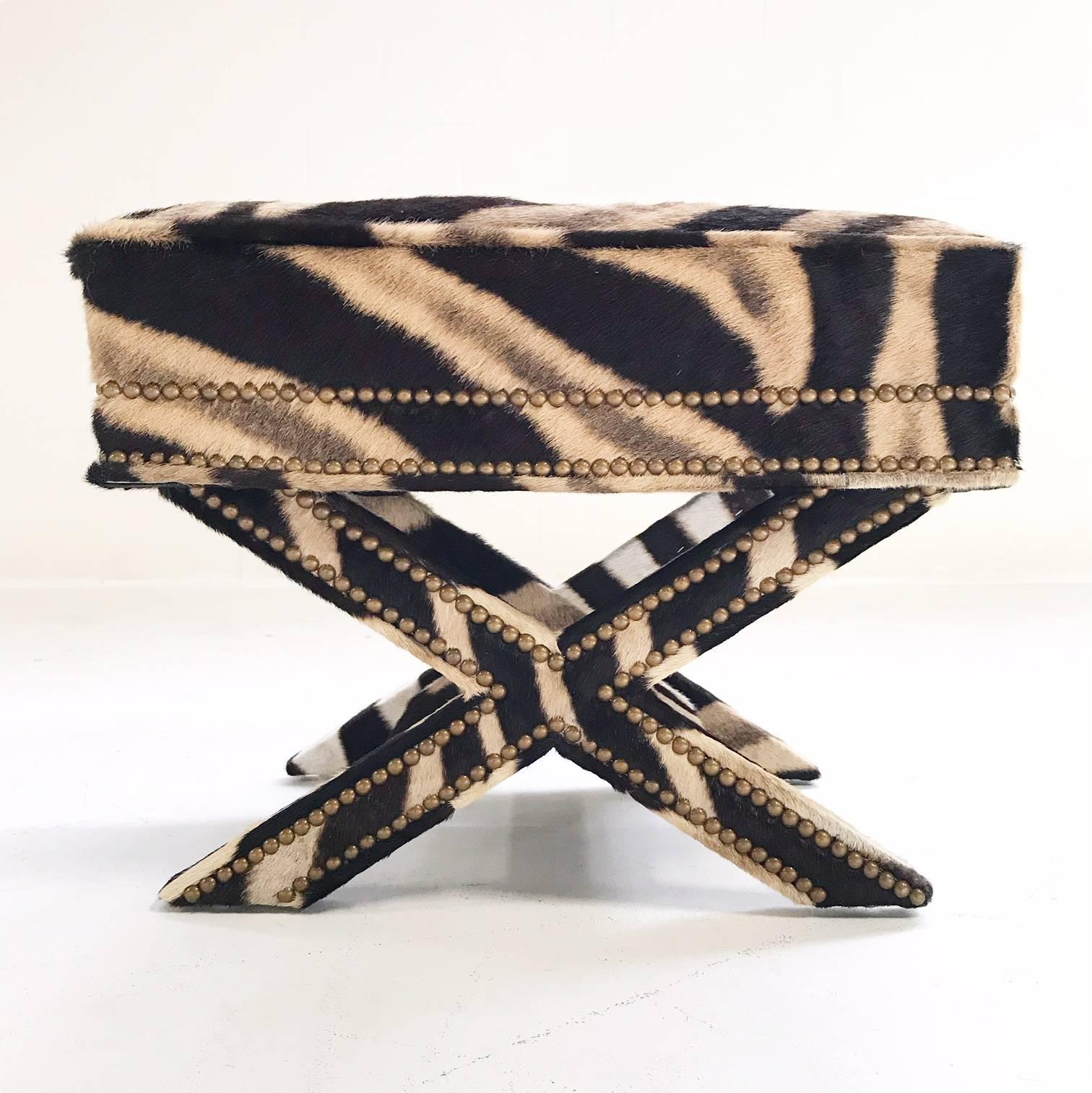 Stunning Billy Baldwin style X bench destined for an amazing room. This is glitter and gold and glamour! The work and craftsmanship to bring this bench back to life is incredible. The luxurious zebra hide is meticulously wrapped around each X shaped