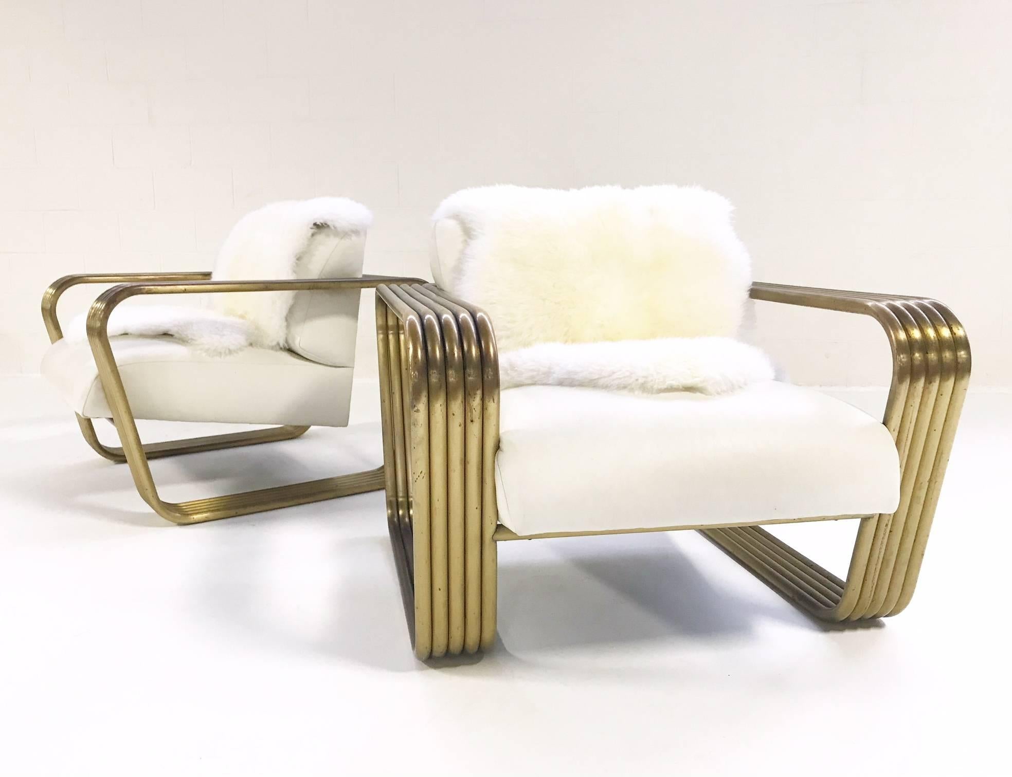 These Art Deco style Jay Spectre lounge chairs (circa 1975) are in such excellent vintage condition we didn't even wanna touch 'em! The tubular brass is perfectly worn and perfectly stellar, the white leather is supple and smooth. 

Measures: 34