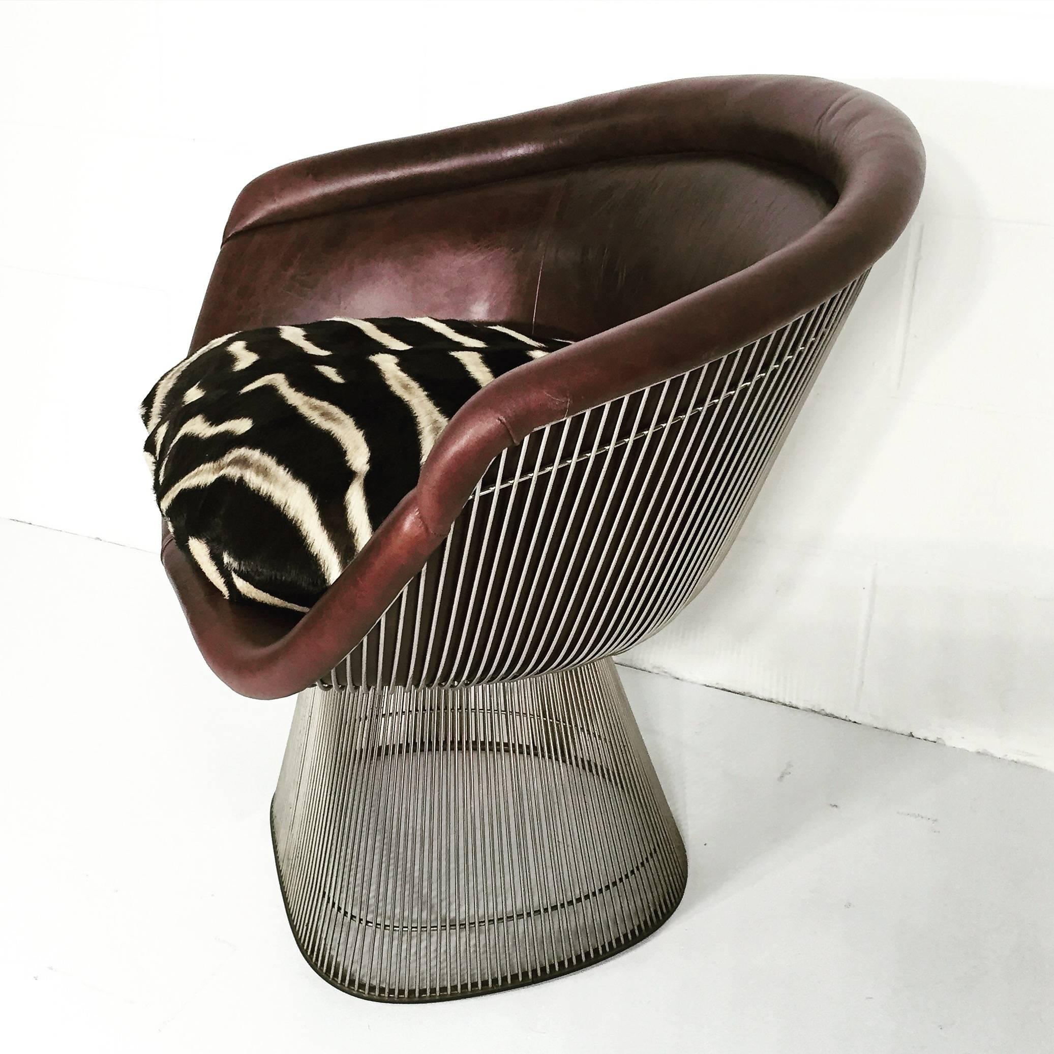 A collector’s item! Released by Knoll in 1966, Platner’s iconic chair lends Mid-Century cool to any room. We chose our signature Forsyth leather so the incredible frame would catch the eye from all angles. A down-filled zebra hide pillow makes for a