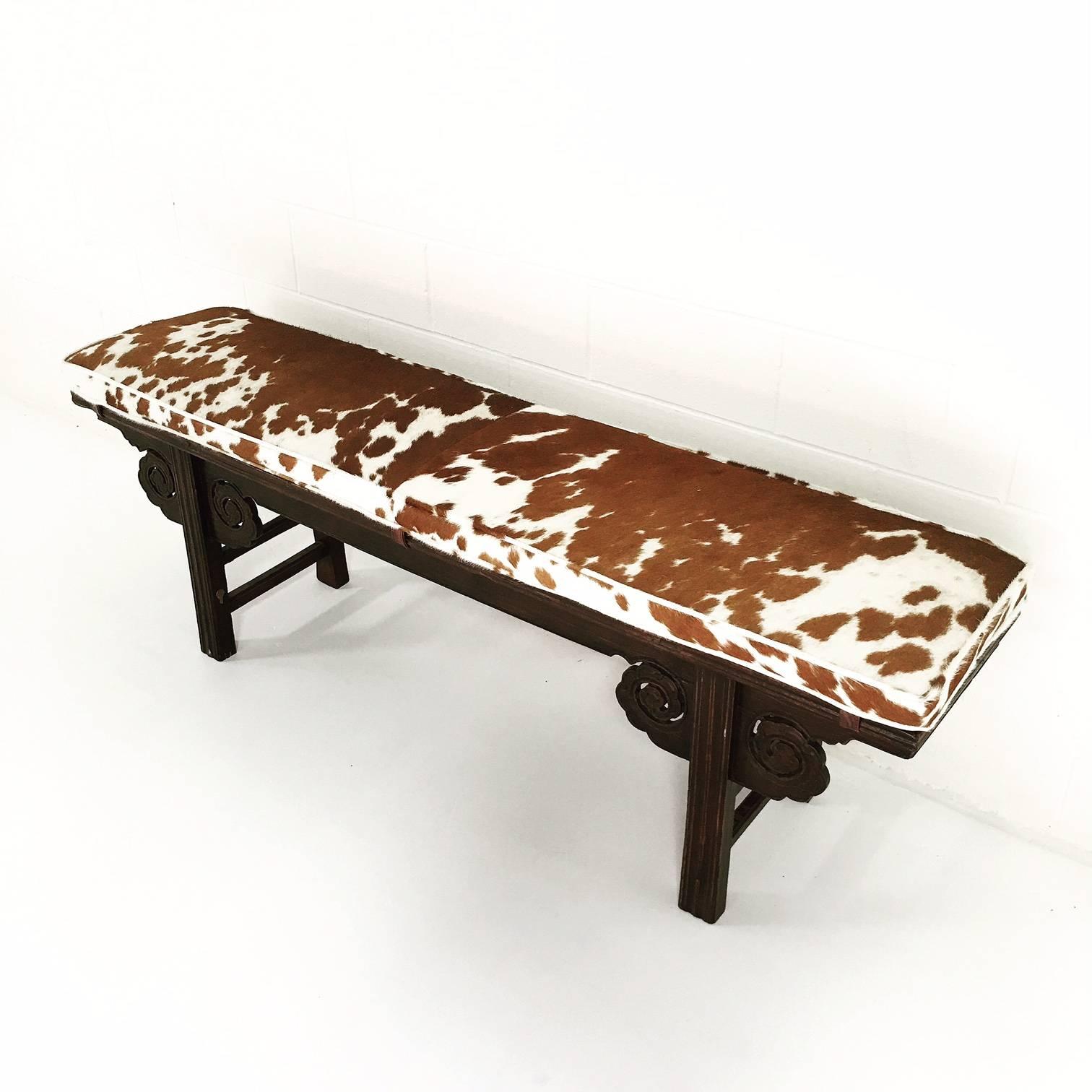 We love the richness of the mahogany colored cowhide together with the red-toned wood of this beautiful bench. Nearly 90 years old from the Tientsin Province of China, this bench is perfect for a kitchen table as it is carved on both sides.