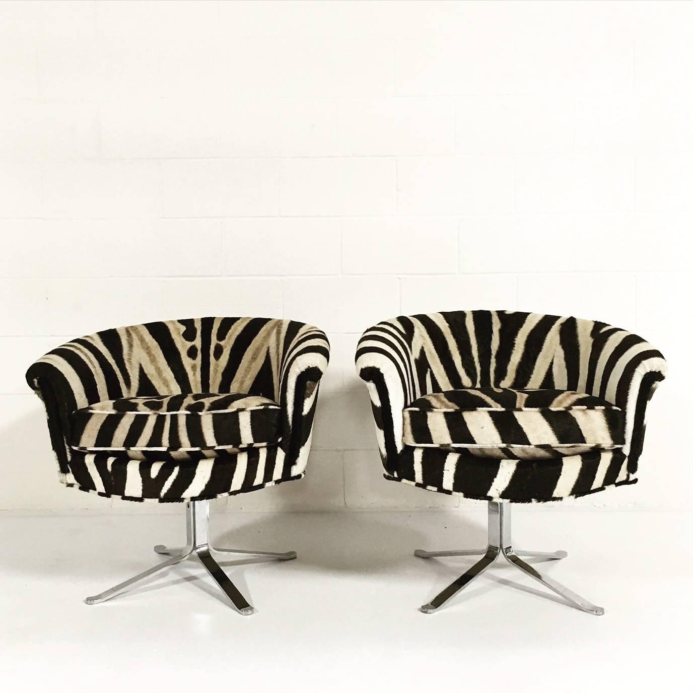 So comfortable, so cool. For office or home, this pair of swivel bucket chairs is irresistibly chic. Masterfully upholstered in zebra hide on a four-star chrome base. By Pace, in the manner of I.M. Rosen