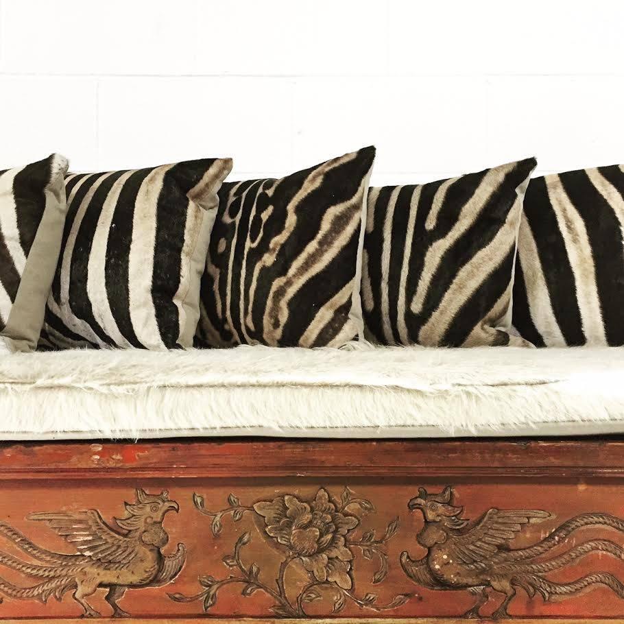 This vintage Chinese carved bench, 80 years old from the Fujian province, was once a console table.  We created a bench with the look, the style, the feel of a world-traveler.  The rare ivory Brazilian cowhide cushion and the down-filled South