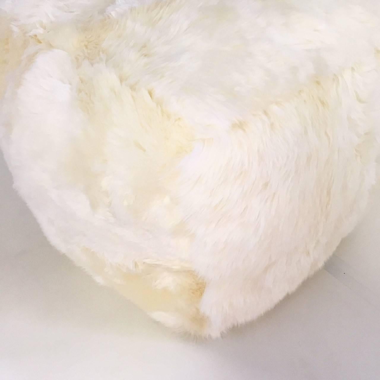Our beautiful, luxurious, softer than a cloud sheepskin cube is handcrafted from our New Zealand sheepskins. The cube is roughly a 20 inch square. Our master upholsterers crafted the cube with no frame. The highest quality foam is used to hold shape