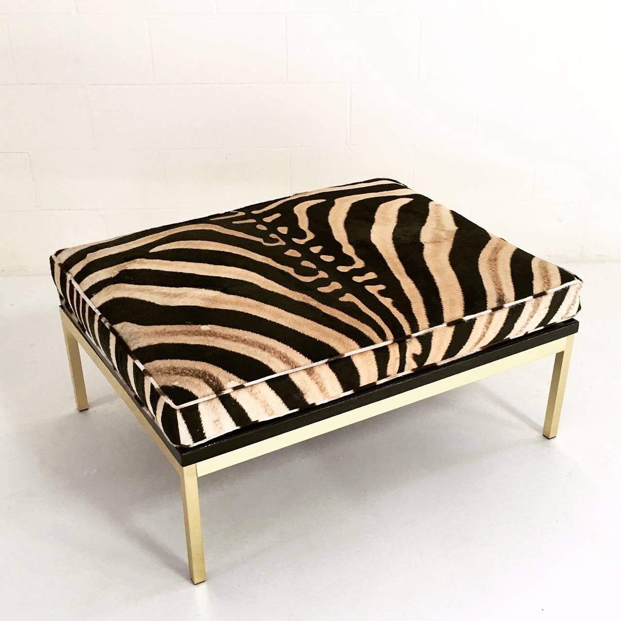 A stunning pair of Knoll style zebra and brass ottomans.
Beautiful, elegant, and minimal enough to fit in any style interior.

We love the simplicity in line and form of this amazing pair of Knoll style ottomans. However, it's the way in which