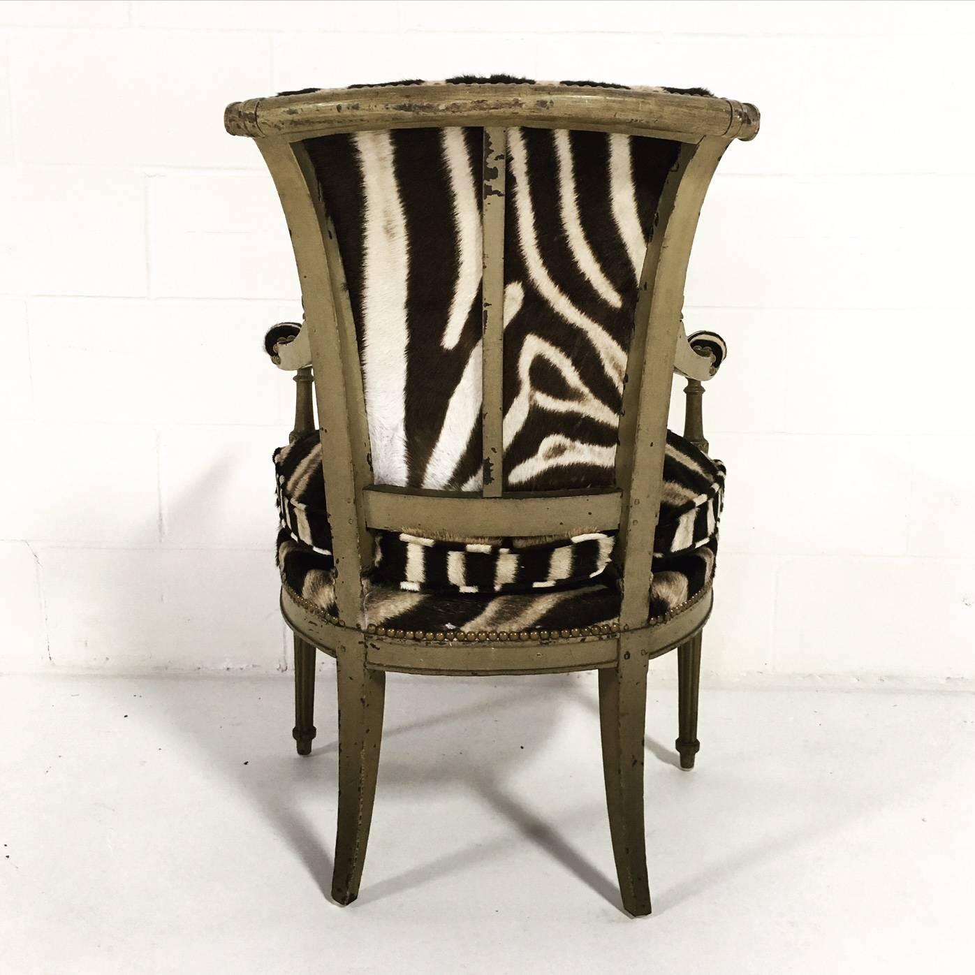 This charming boudoir chair has been masterfully upholstered in Burchell's zebra hide. We love the curving back and the loose cushion. The expert upholstery is finished with brass nail heads. The perfect accent chair.