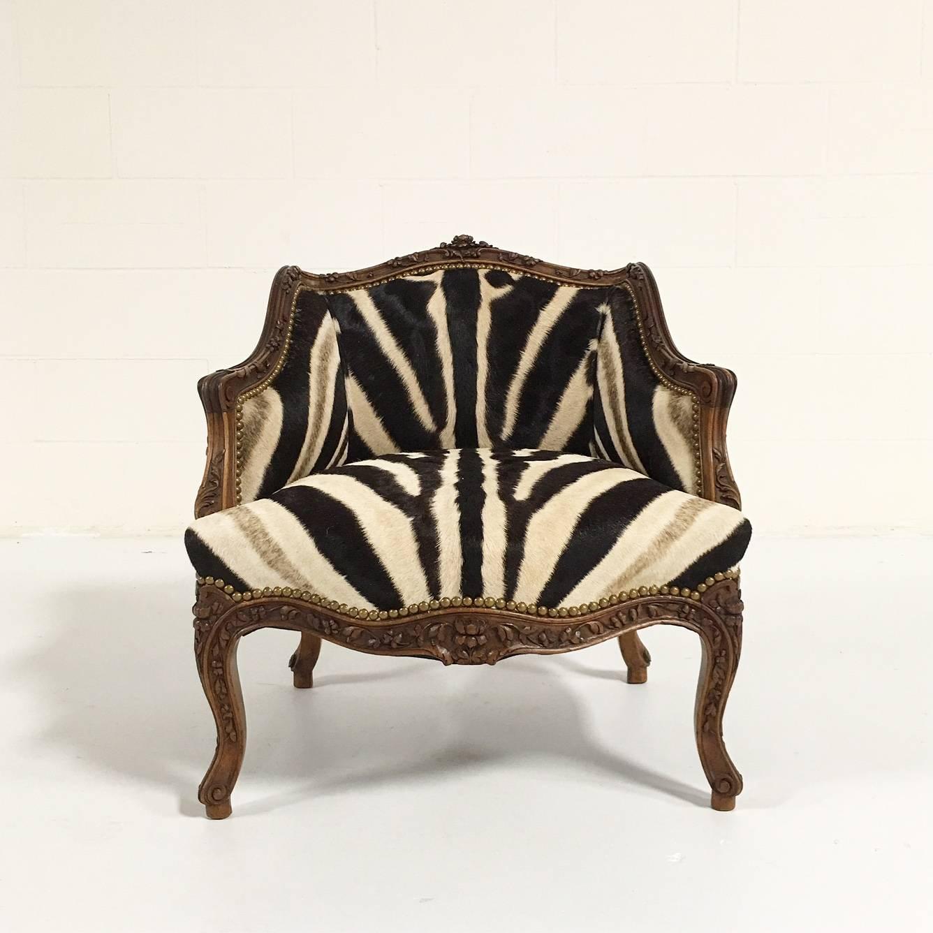 This petite chair is a conversation piece! The intricate carving with rose motifs pairs perfectly with the textured zebra hide upholstery and brass nail heads. We picture this darling thing in a dressing room or bathroom or even in the corner of the