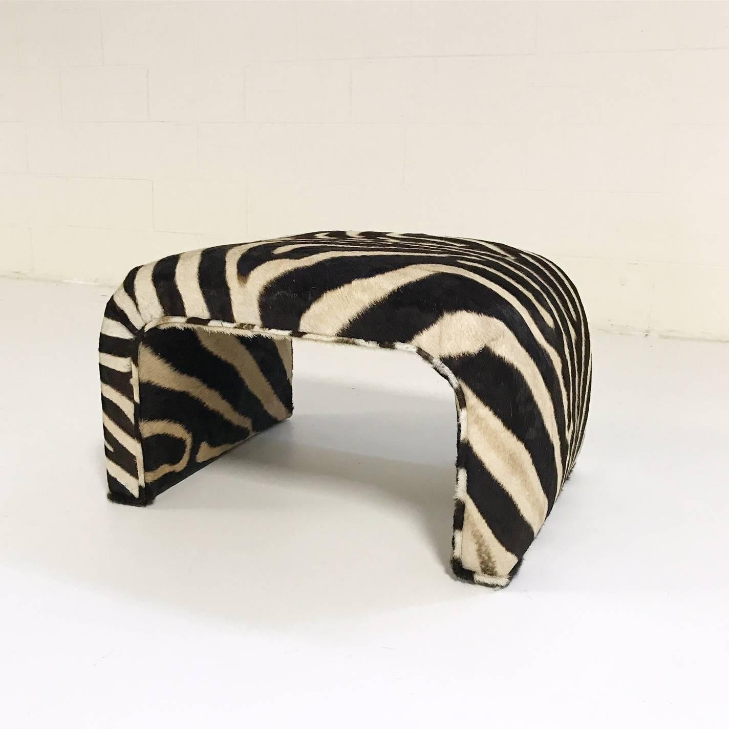 We collected this ottoman for its unique shape.  The entire piece has been meticulously reupholstered in zebra hide.  There is no seam on the top.  It's a beautiful piece and the perfect accent in front of any chair.