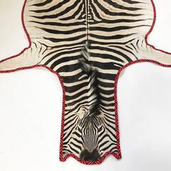 Zebra Hide Rug Trimmed in Maasai Warrior Blanket