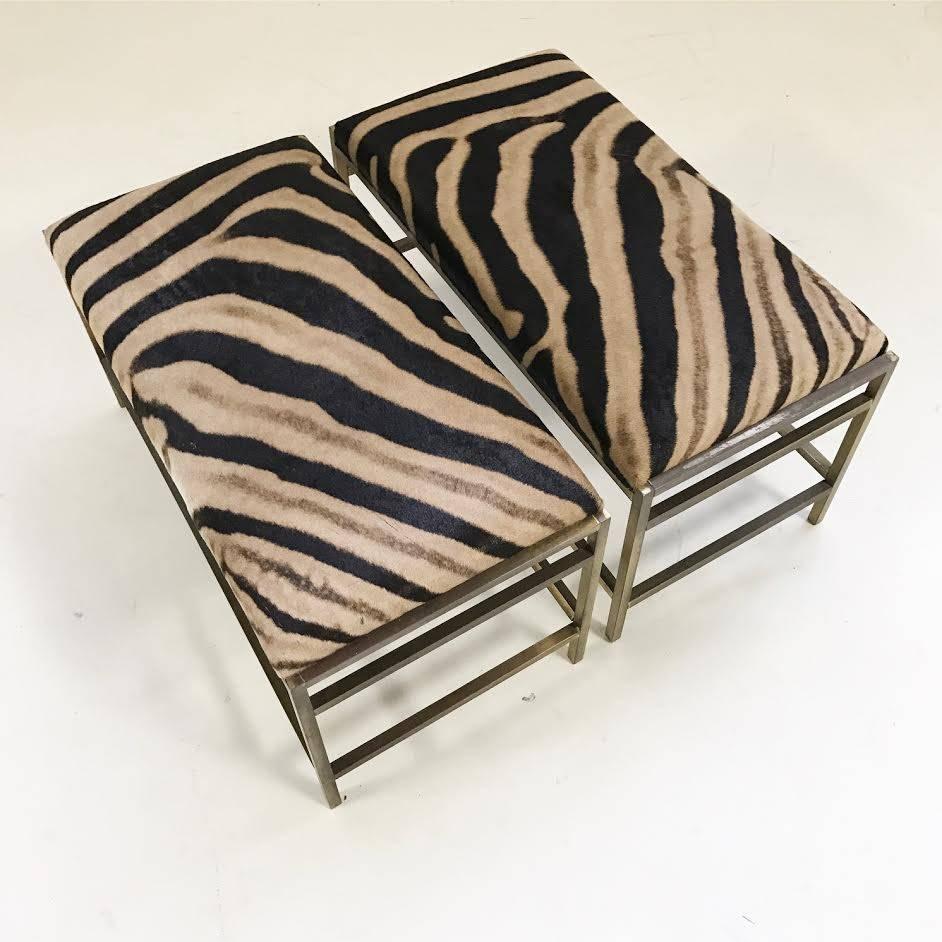 Stunning lines on this pair of Paul McCobb style benches. One zebra hide was chosen for both benches and artistically upholstered so the stripes match when they are placed side by side. The hide coloring also has the same warm golden tones as the