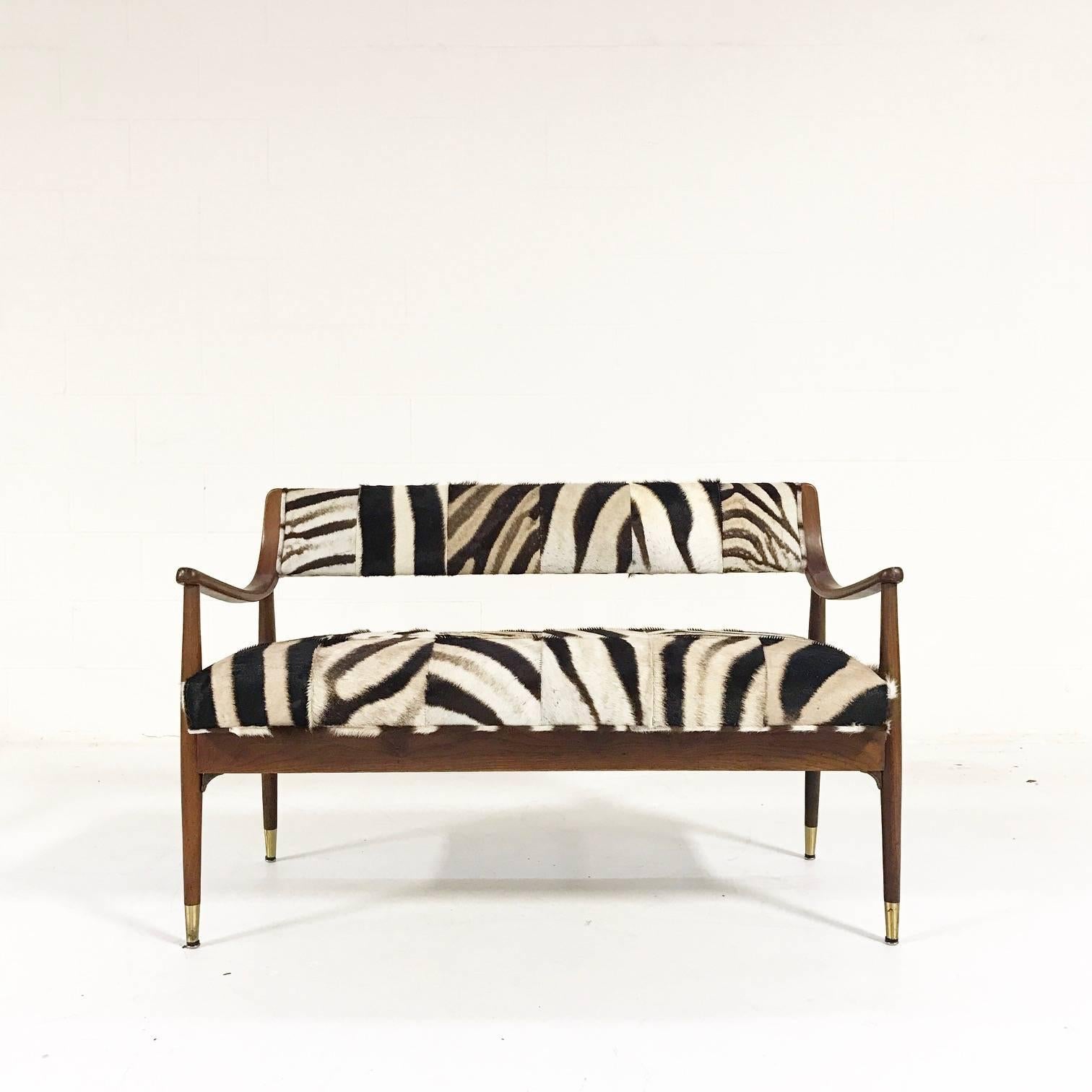 We love the combination of the hand-cut and hand-sewn patchwork zebra hide with this simple, elegant Danish settee. There is something so visually stimulating about patches of zebra hide. The chaos of stripes going every which way, the black and