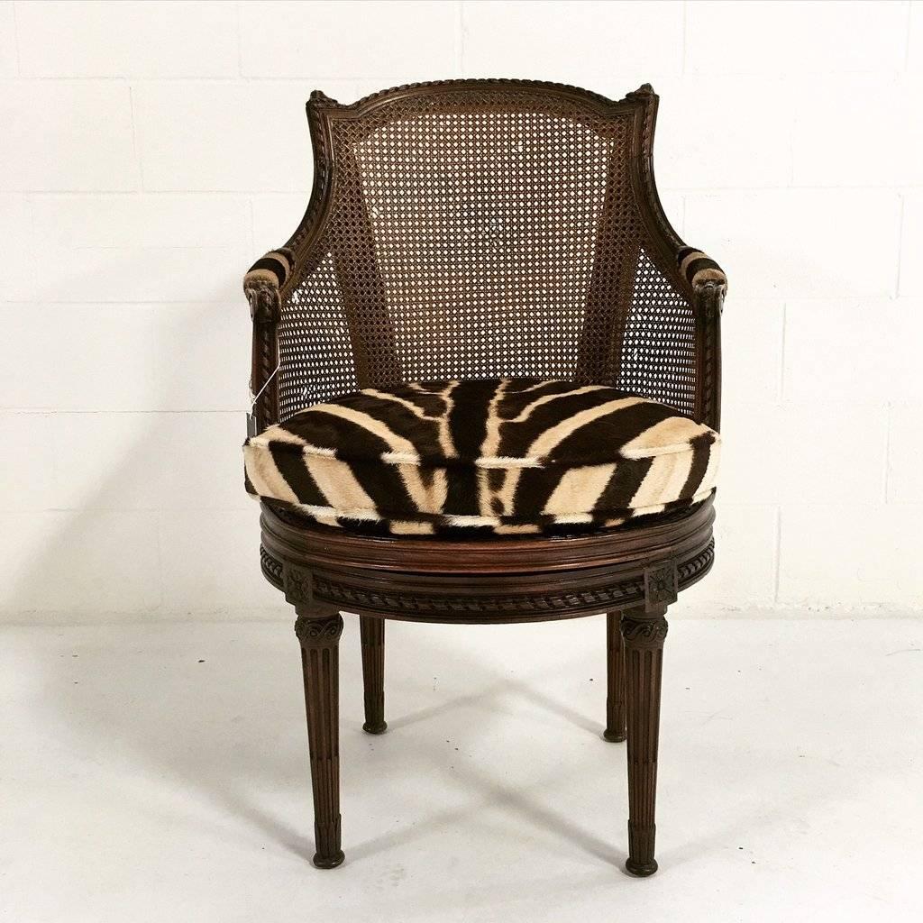 This beautiful, antique mahogany and cane bergere swivel chair is a rare find. We created a custom loose zebra hide cushion and also reupholstered the magnificent arm rests in zebra. The chair bears the stamp of the maker, G. Jacob. 

France, 18th