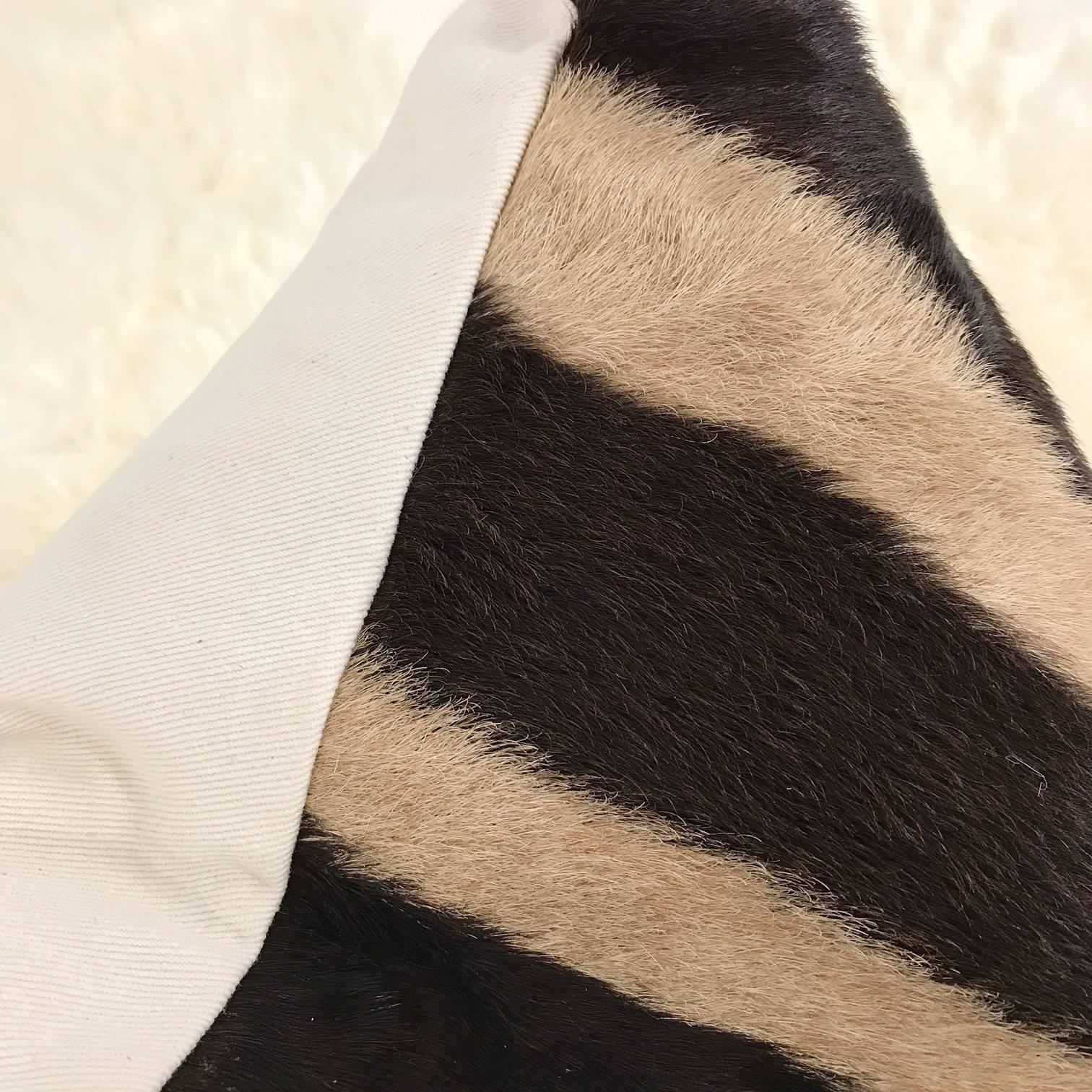 Forsyth zebra hide pillows are simply the best. The most beautiful hides are selected, hand cut, hand-stitched and hand stuffed with the finest goose down. Each step is meticulously curated by Saint Louis based Forsyth artisans. Every pillow is a