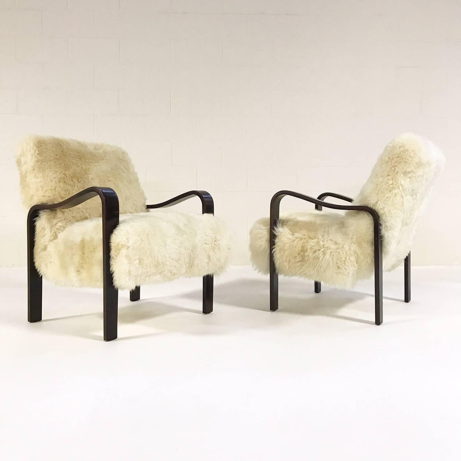 So comfortable. We wish we could keep these for ourselves. We love the sculptural yet graceful and fluid arms that effortlessly become the legs. Our designers chose our rustic Brazilian sheepskin for the material to counter the smooth wooden arms.