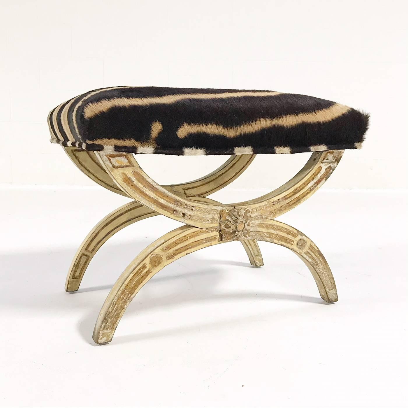 A prime example of a 19th century Regency painted stool. Having a rectangular cushion seat restored and reupholstered in zebra hide, raised on fluted X-form supports and joined by a stretcher. So fancy. So chic.

Measures: 24in W x 17in D x 18.5in
