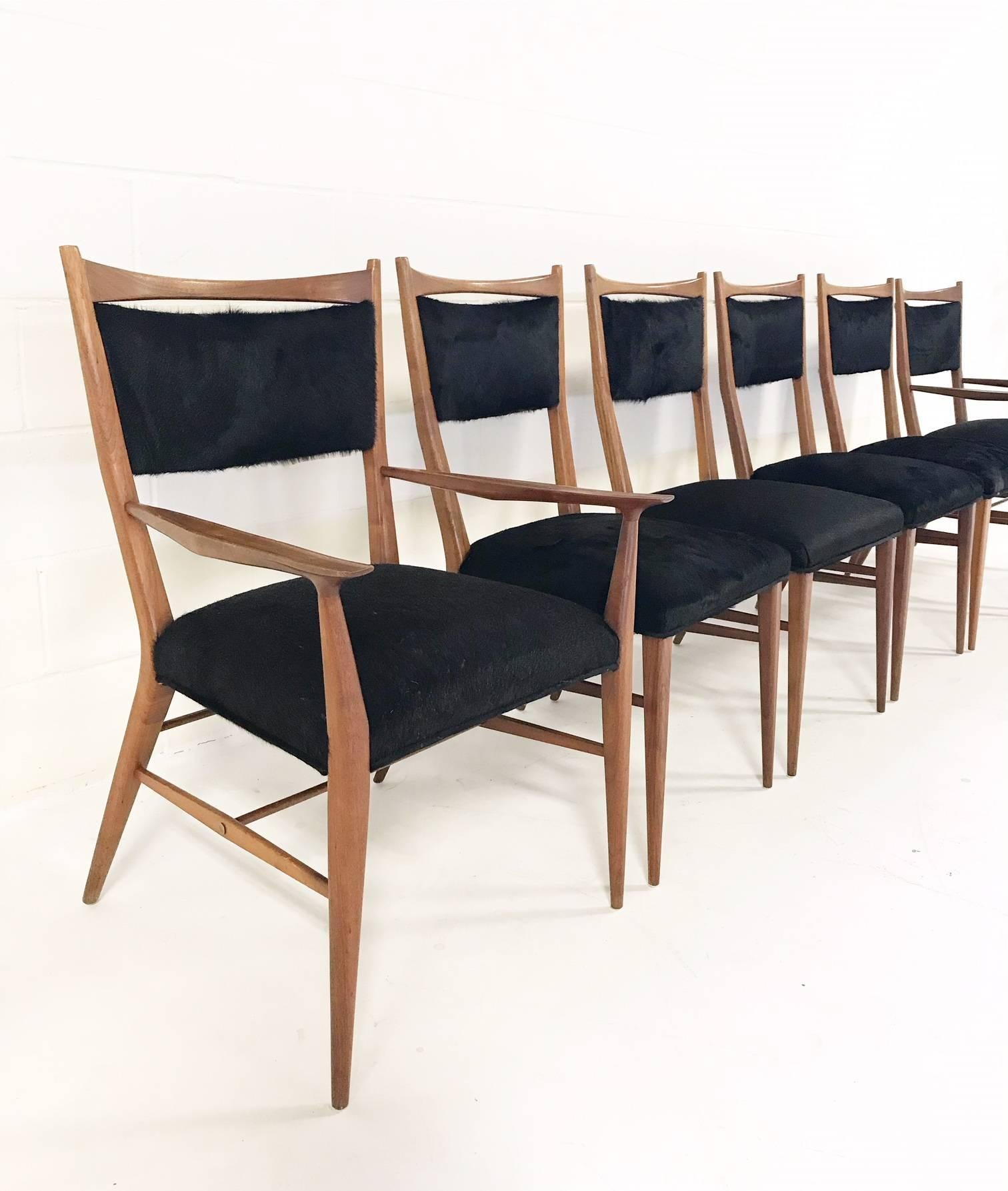 This exceptional set of walnut dining chairs was designed by Paul McCobb for Directional. 

Directional furniture was the high end of McCobb's various design endeavors of the 1950s. To maintain the uber sleekness of this beautiful set, our #1