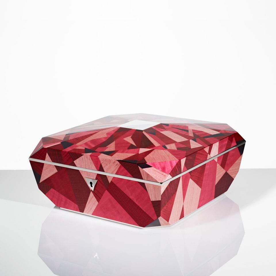 The Ruby is created from a stunning Myriad of different hues to match the glimmering facet cuts of an exquisite ruby. Each veneer is hand-dyed and precisely pieced together in an abstract marquetry pattern to reflect the angular form.

The Ruby is