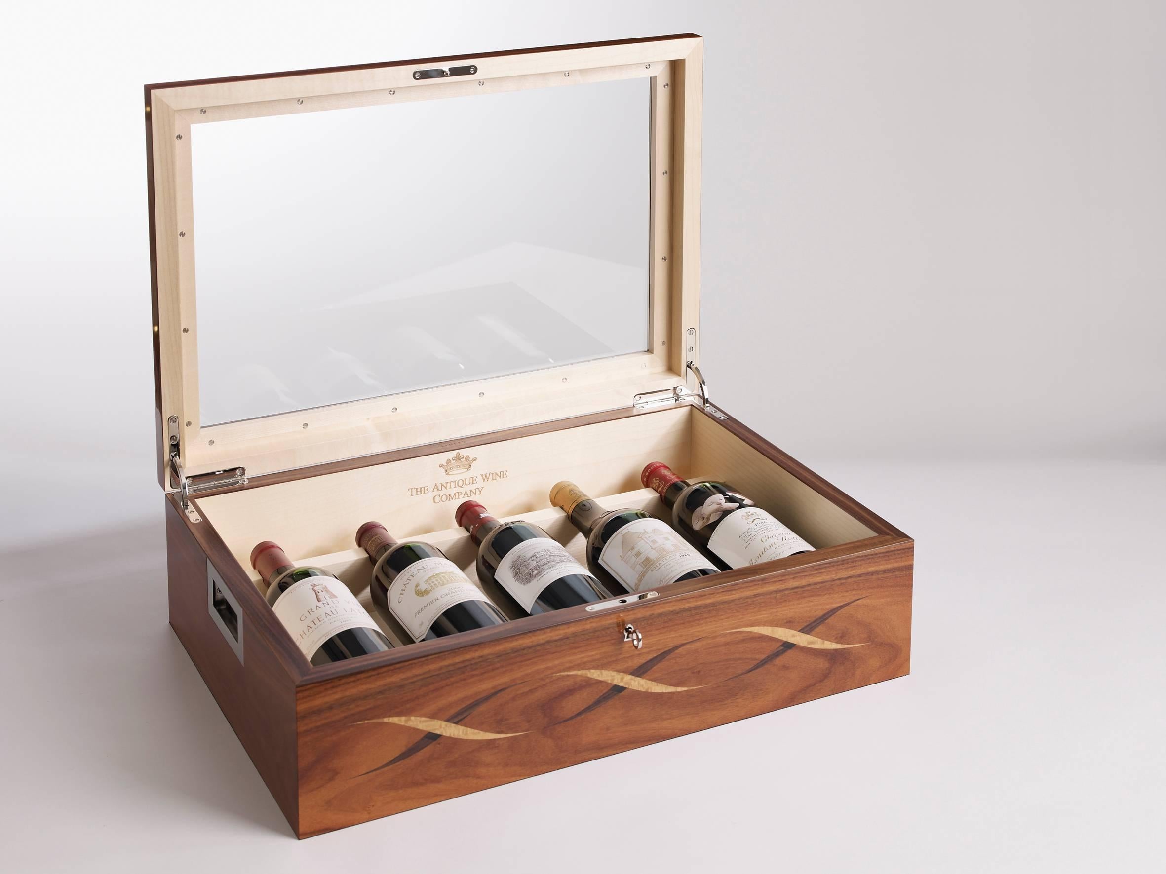 The predominant feature of the wine box is the intertwined twin strands of the double helix, or the unit cell of DNA in marquetry inlay. This motif characterizes the iconic Helix furniture collection and has been applied using the technique of