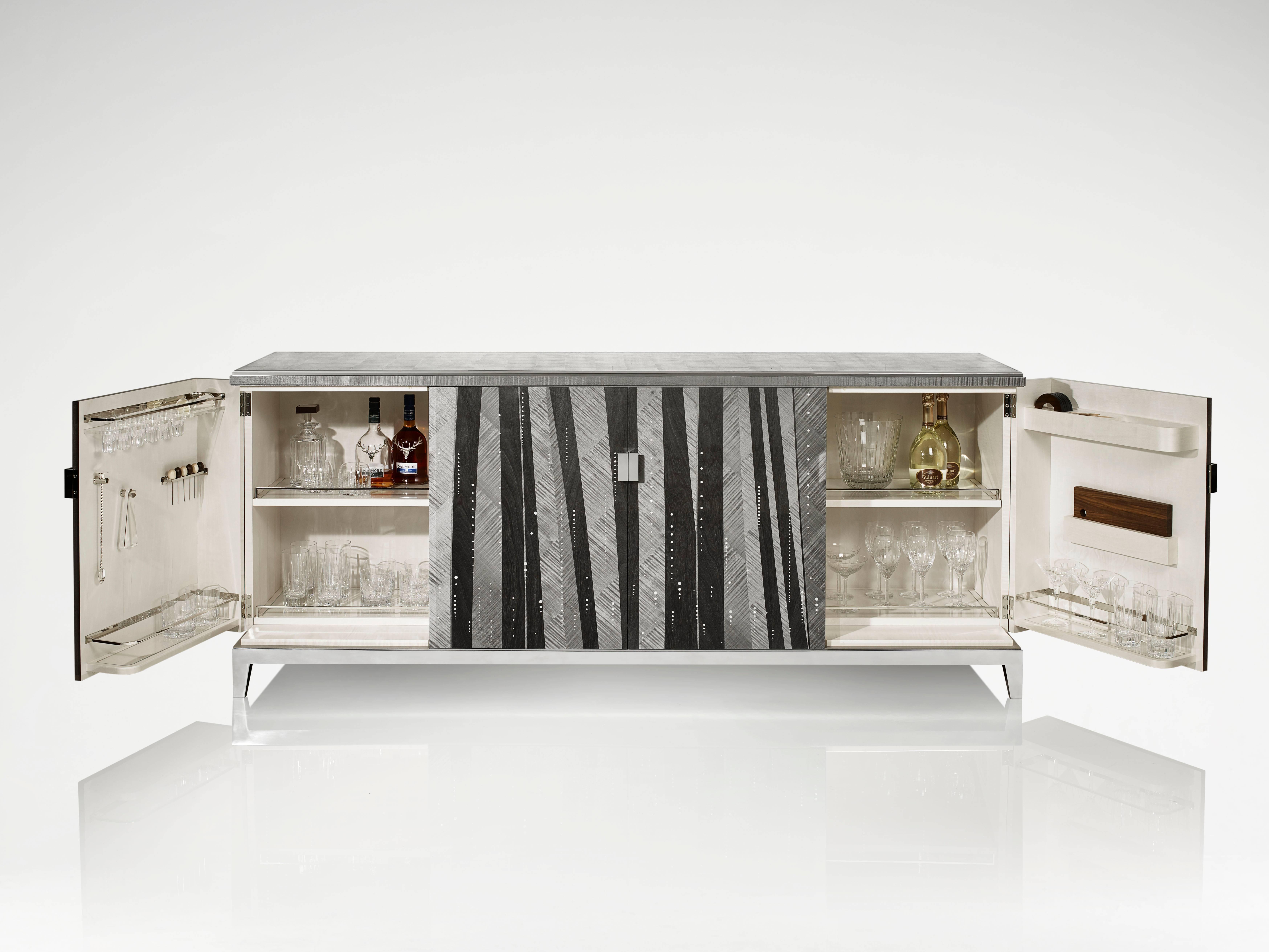 Inspired by our popular Trafalgar cocktail box, this elegant cocktail cabinet has been handcrafted in hand-dyed charcoal veneers of ripple and straight sycamore. The eglomisé surface has a nickel trim and is highlighted with mother-of-pearl