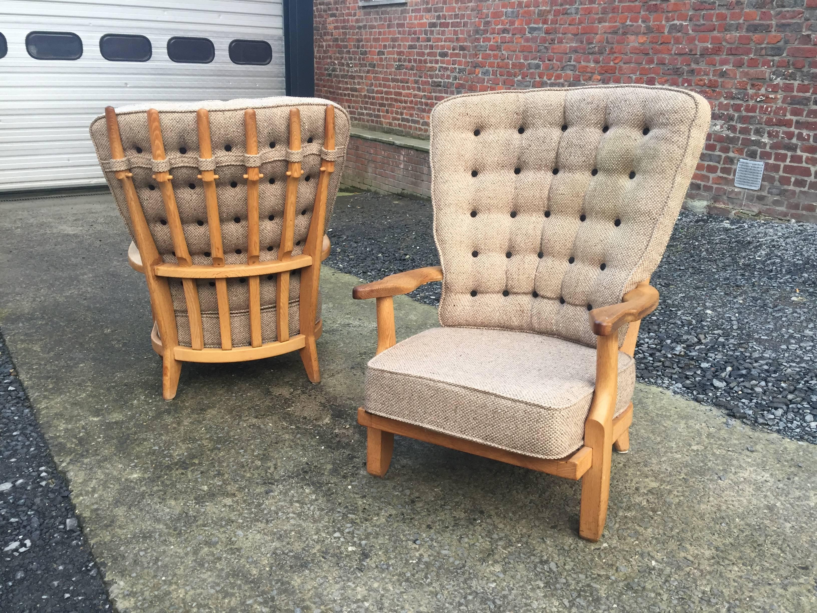 Guillerme et Chambron, pair of grand repos oak armchairs. Edition Votre Maison.