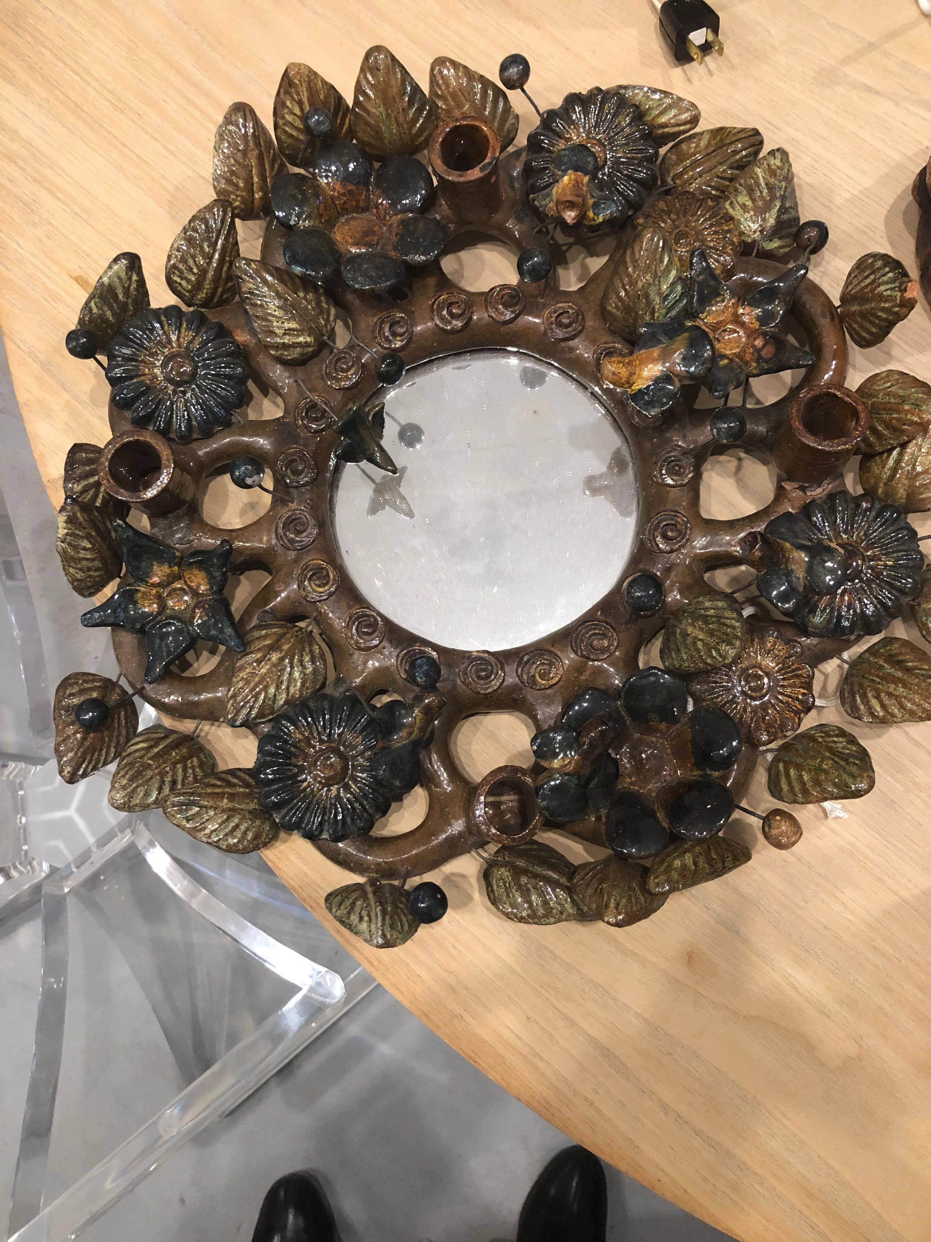 A ceramic flowers leafs mirror.