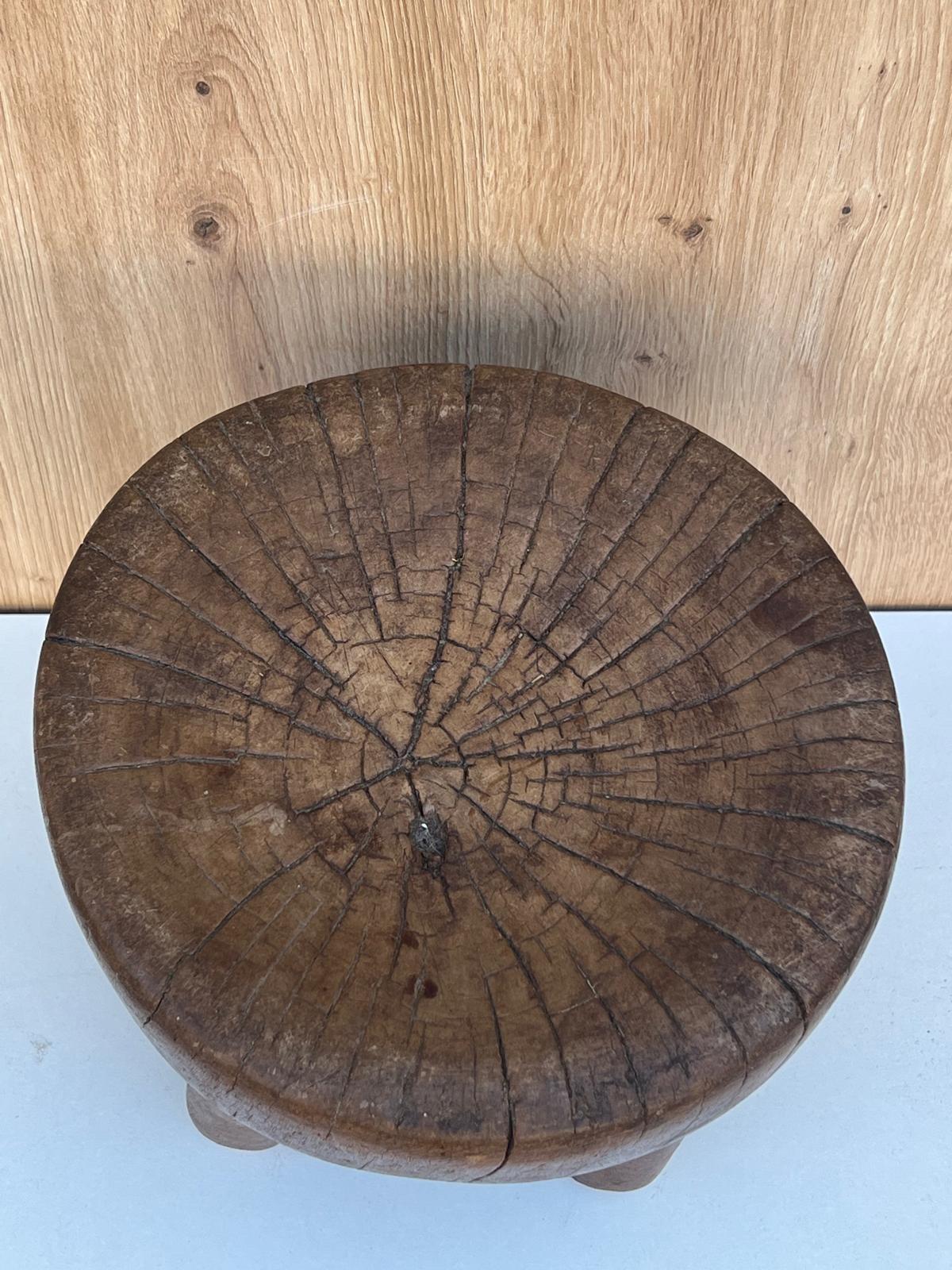 A low oak stool with an African style