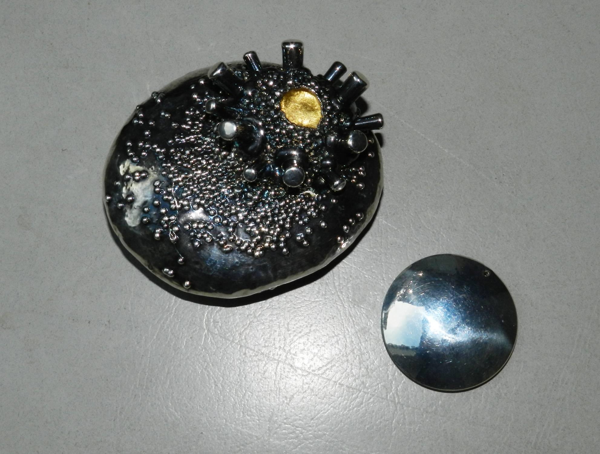 Spilla di Giorgio Vigna in argento e vetro di murano su foglia d'oro. Il sistema è un magnete