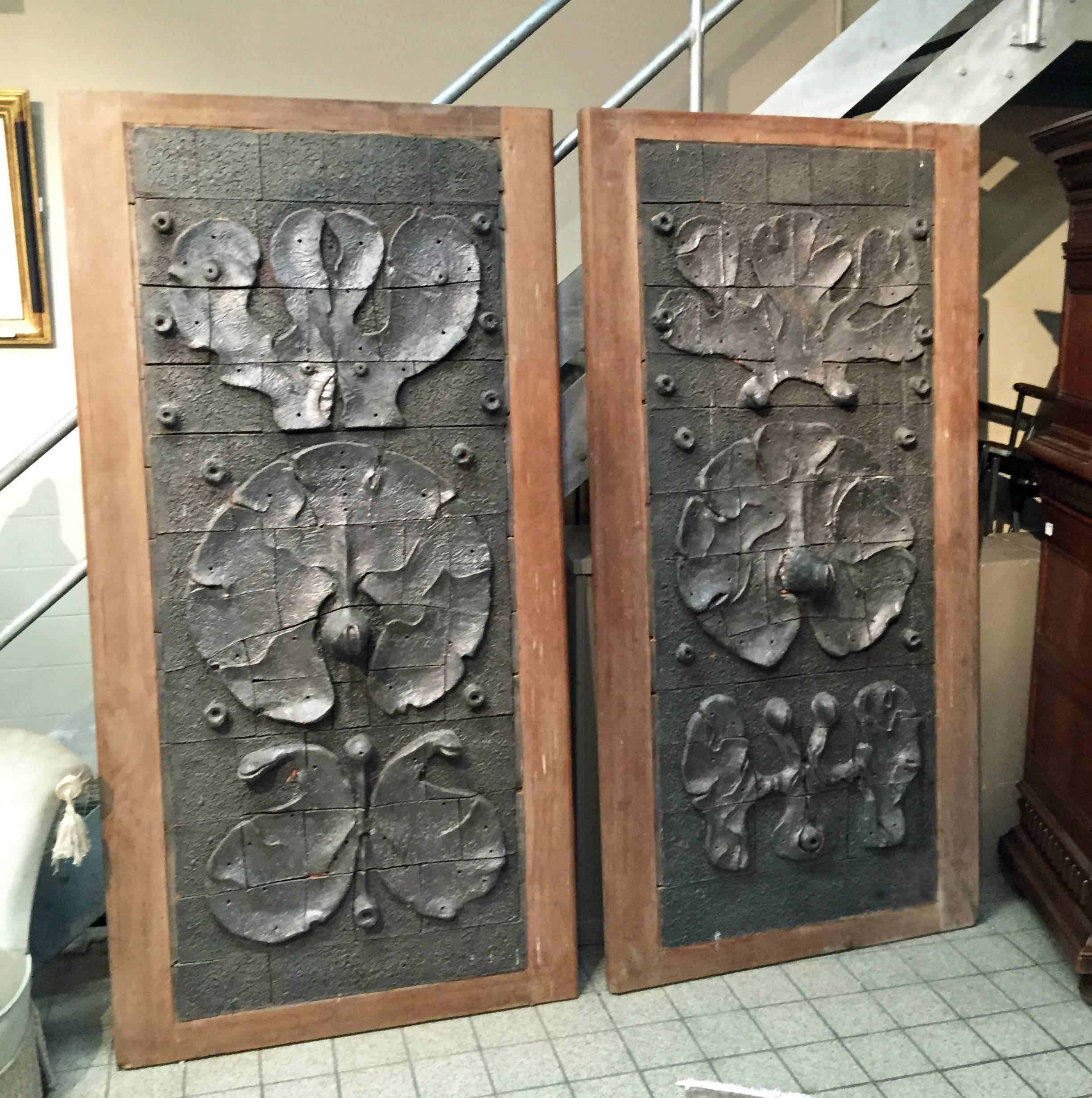 Yves Rhayé (1936-1995), exceptional sliding doors with ceramic design, circa 1970. 
Back and frame in solid oak.
Back with Louis XV style molding panel. 
Measures: 202 x 102 cm each
These doors were created for a house in Bruxelles.
A few books