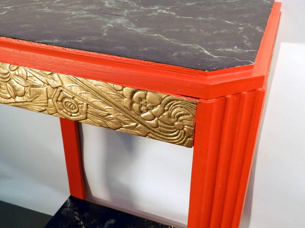 Amusing pair of Art Deco consoles, circa 1930-1950.
Gilded and red lacquered. Marble imitation painted on the top.
 