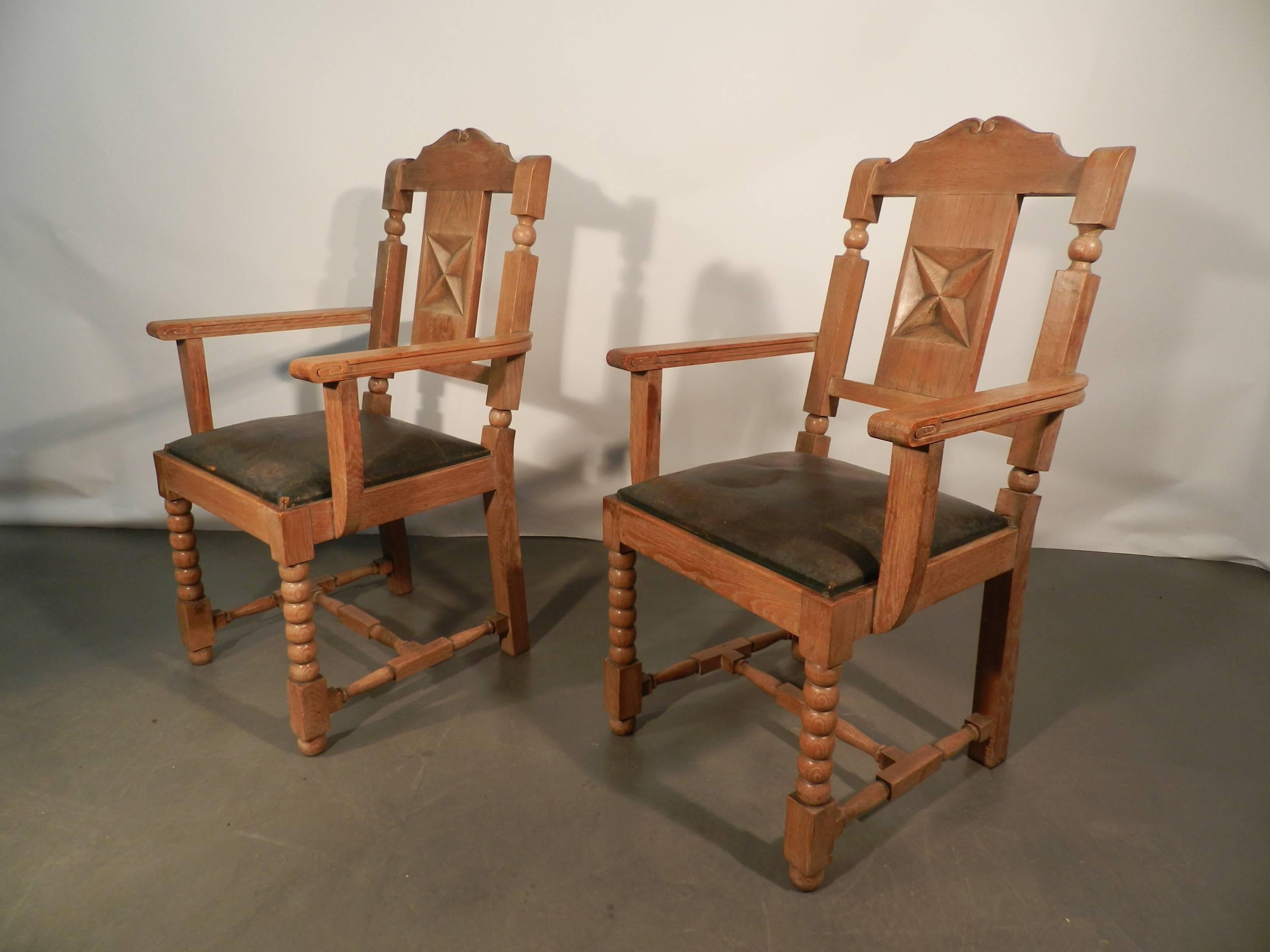 In the style of Charles Dudouyt, two neo rustique oak armchairs.
Leather damaged.