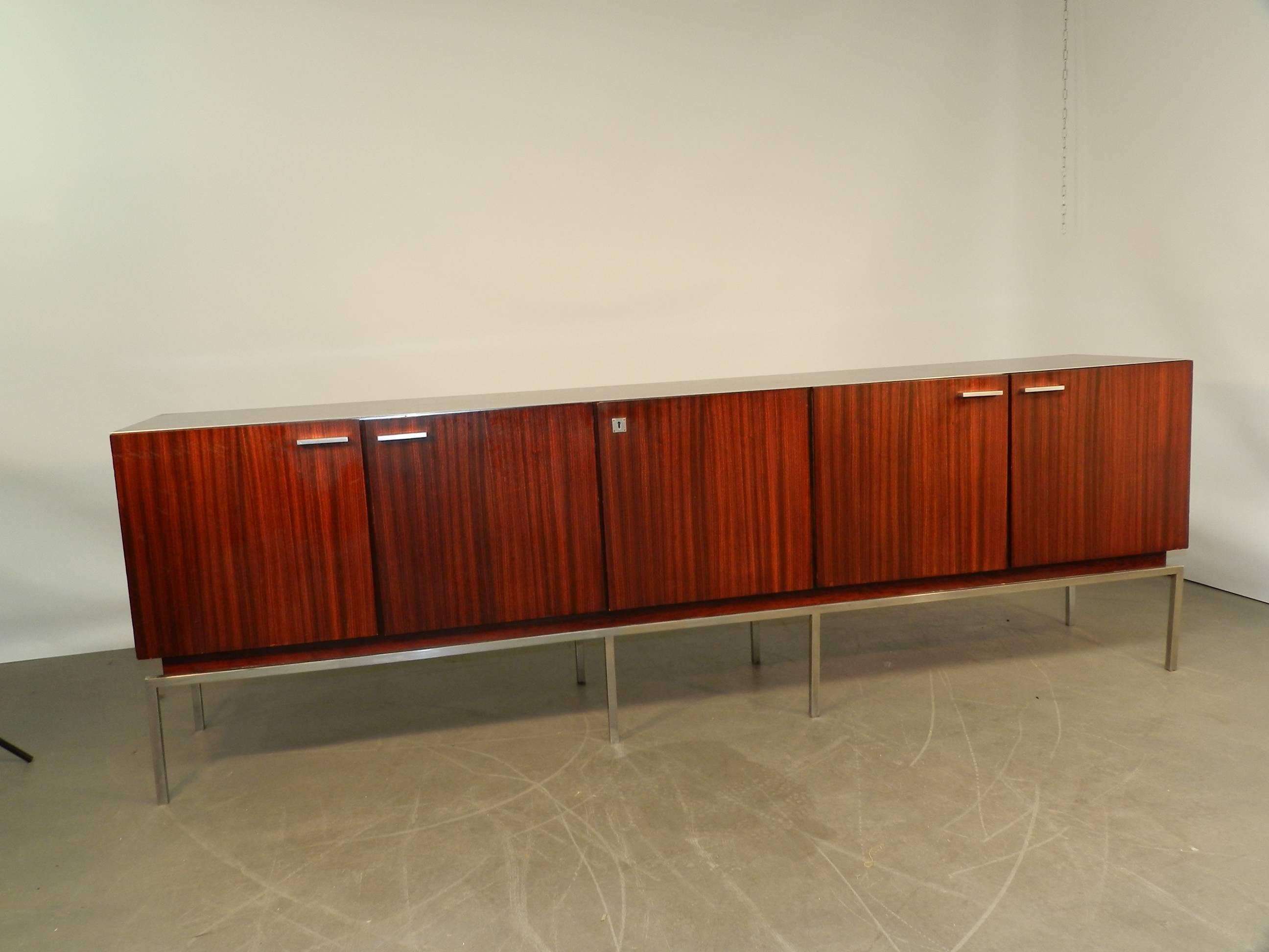 Large 1960, mahogany veneer sideboard opening with five doors.
