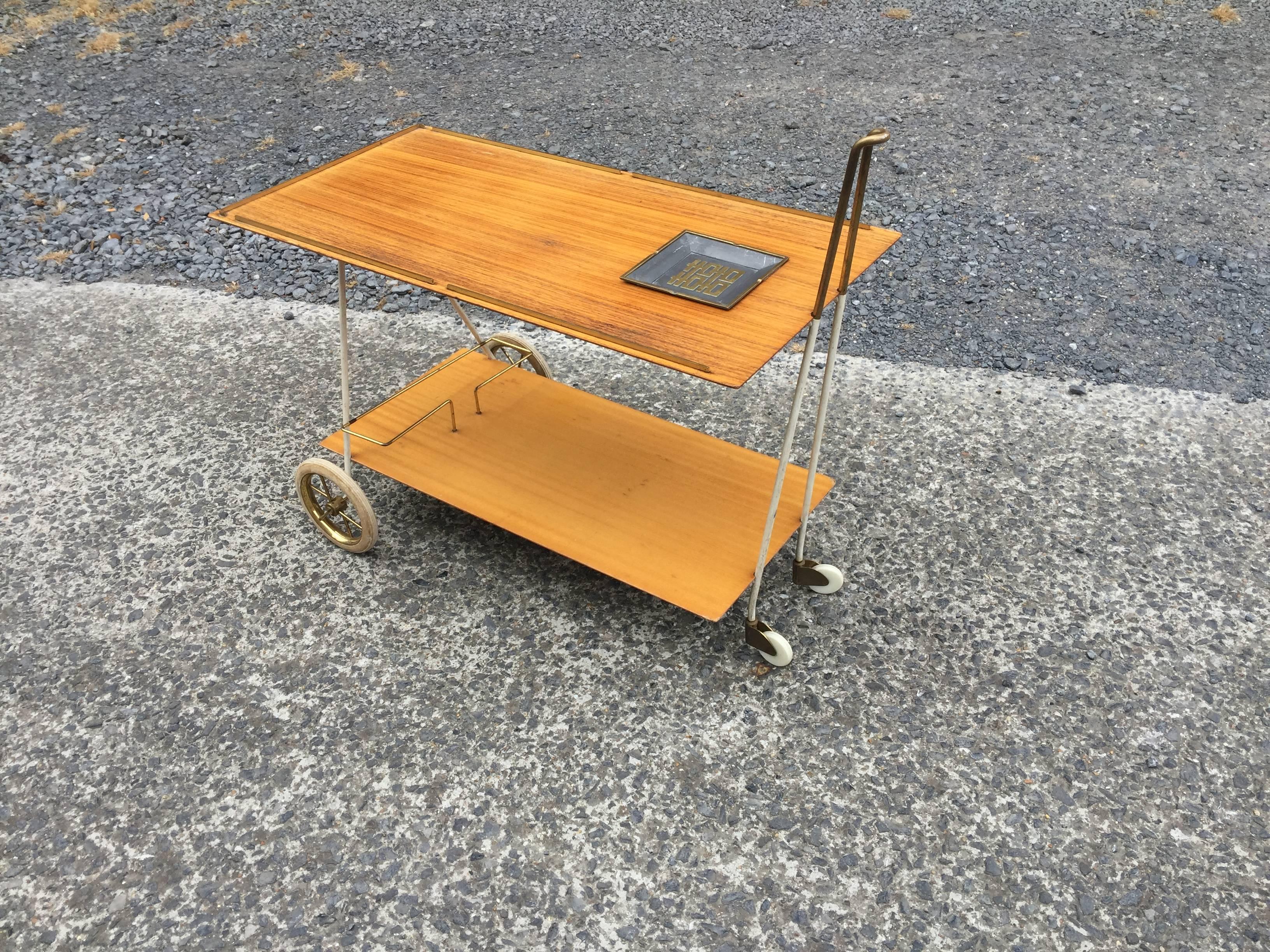 Rosewood, brass and lacquered metal trolley, circa 1960.