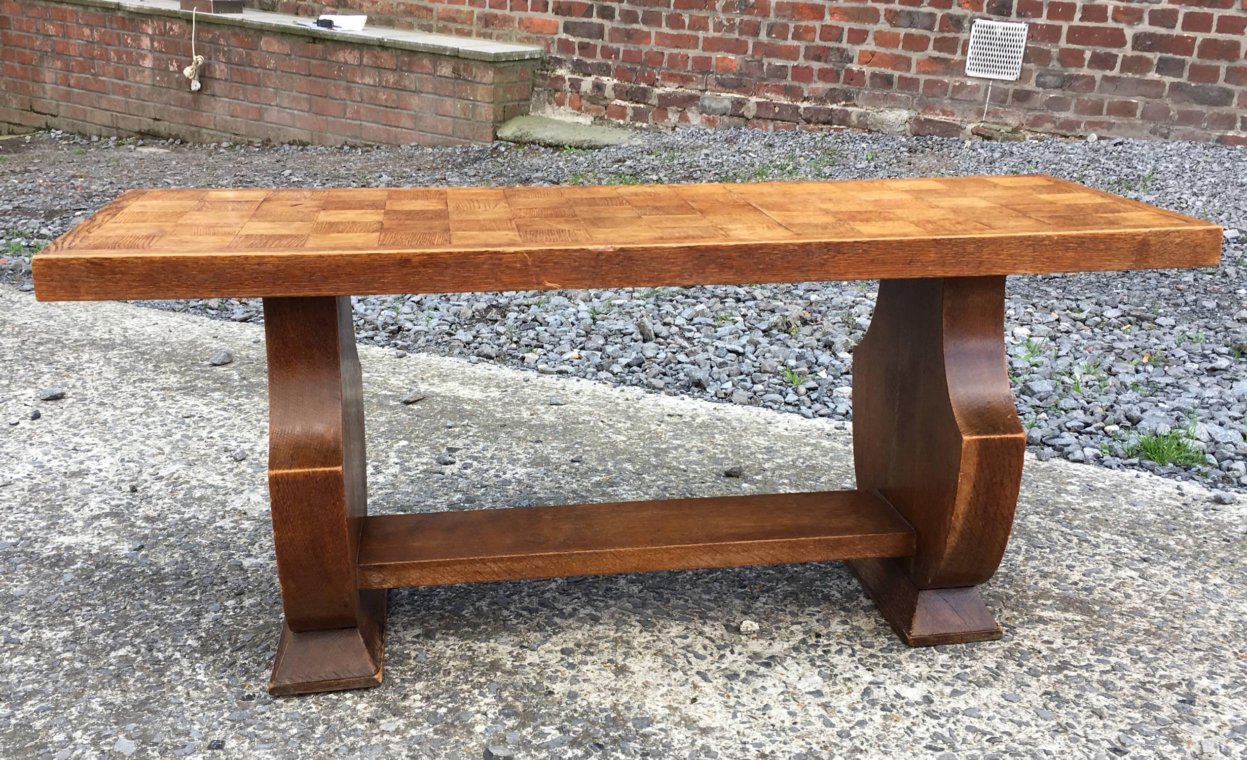 In the style of Jean Charles Moreux, oak coffee table, circa 1940.