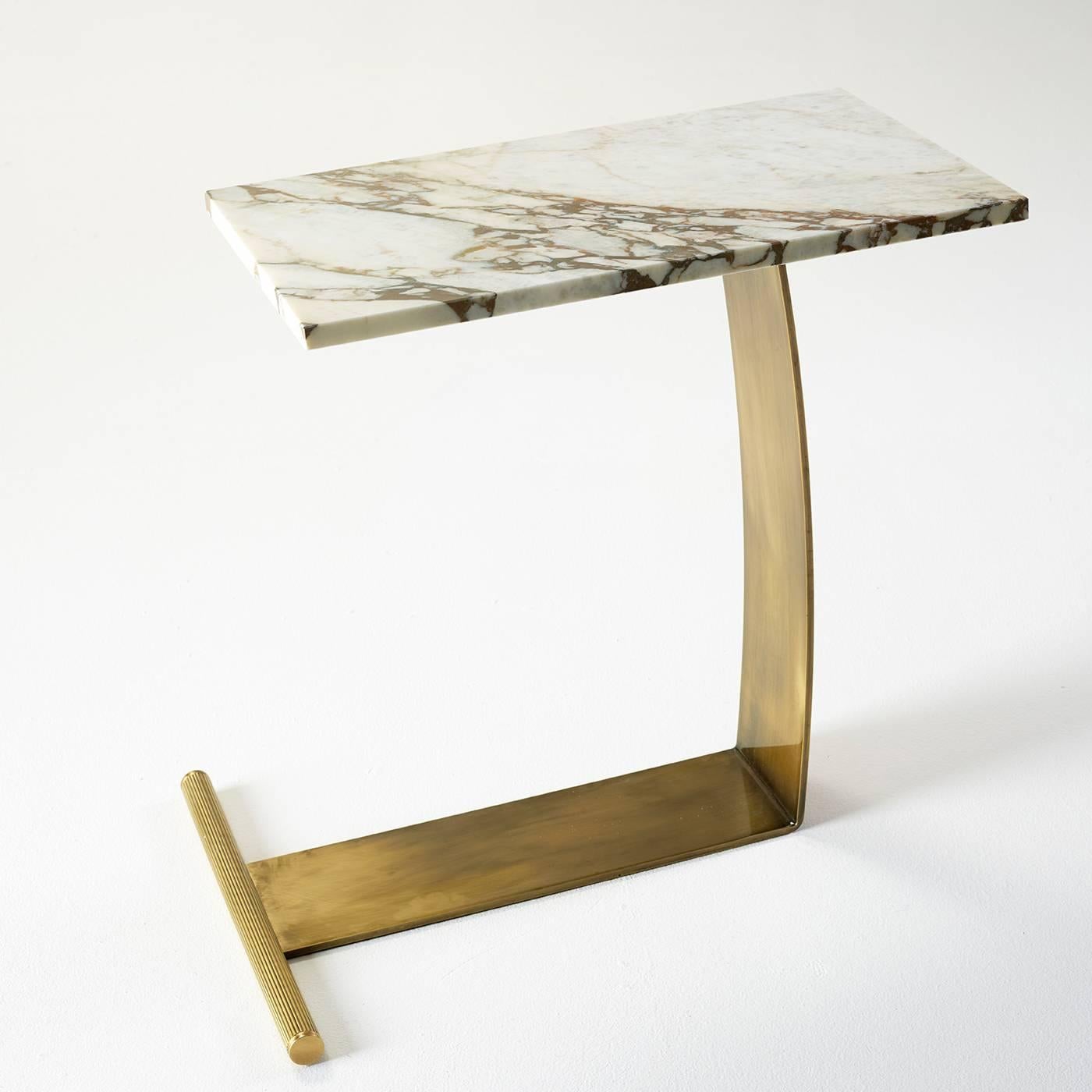 This table is a signature creation of Florentine furniture maker Marioni. The L-shaped brass base supports a lavish white veined marble top.
