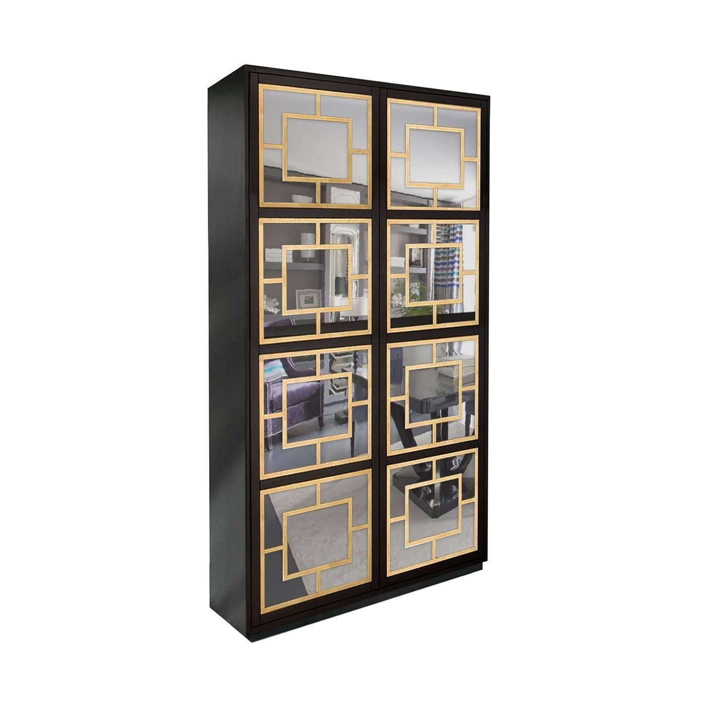 This two-door cabinet is handcrafted by expert artisans and has a simple structure with a plinth base and a striking matte black lacquer finish. It features two mirrored front panels with a push-to-open mechanism, overlaid with gold leaf