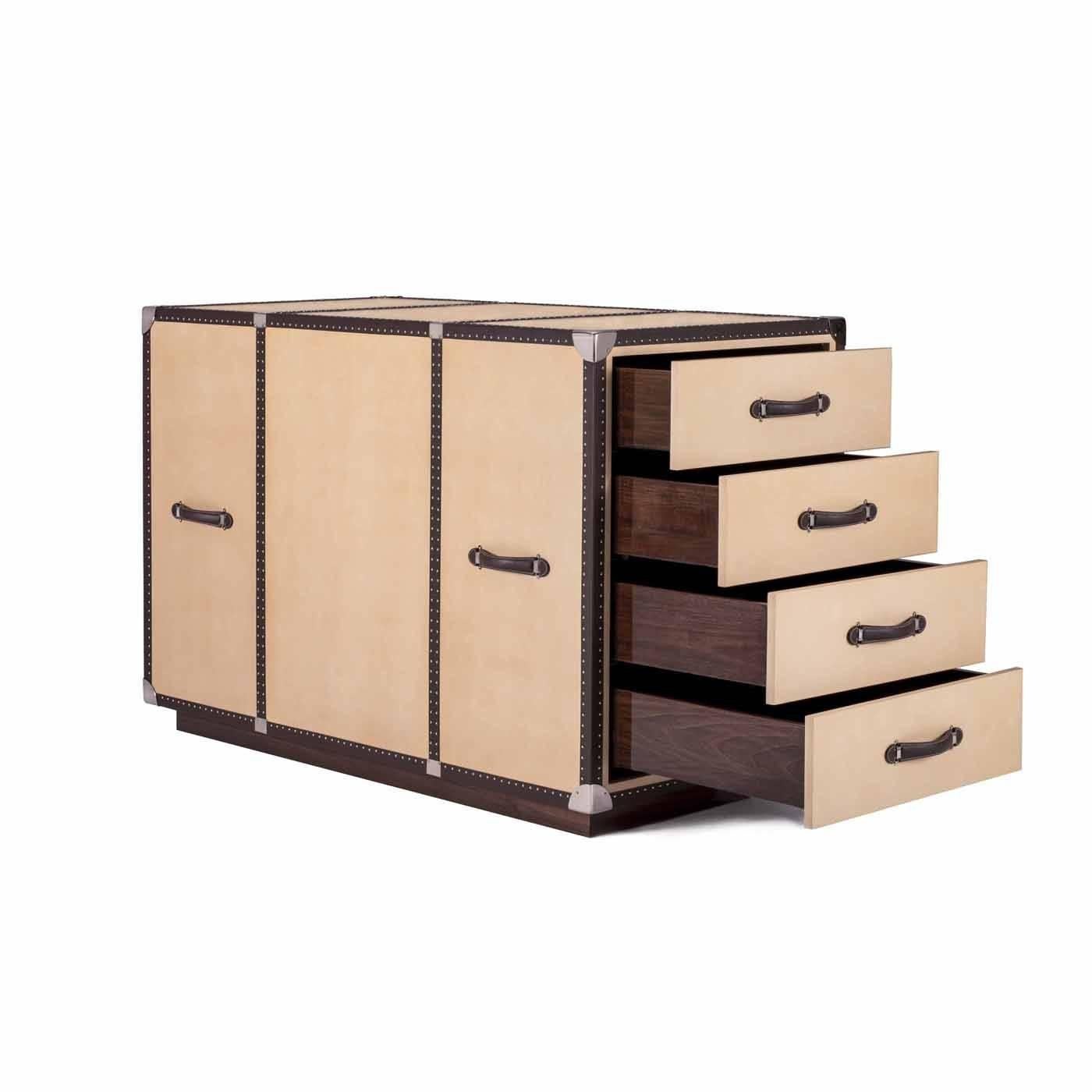 This exquisite trunk evokes the design of the roaring 1920s and can be displayed at the center of a room. The structure is in poplar wood with wheels at the base for easy mobility and the exterior is covered in leather. The interior contains eight