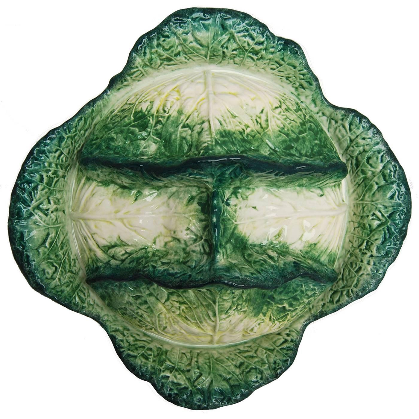 Ceramic soup tureen shaped like a Savoy cabbage and functionally executed with the “vegetable” adequately placed inside a basket-shaped bowl with the same texture. The piece is crafted and painted by hand by the master ceramic artists in the