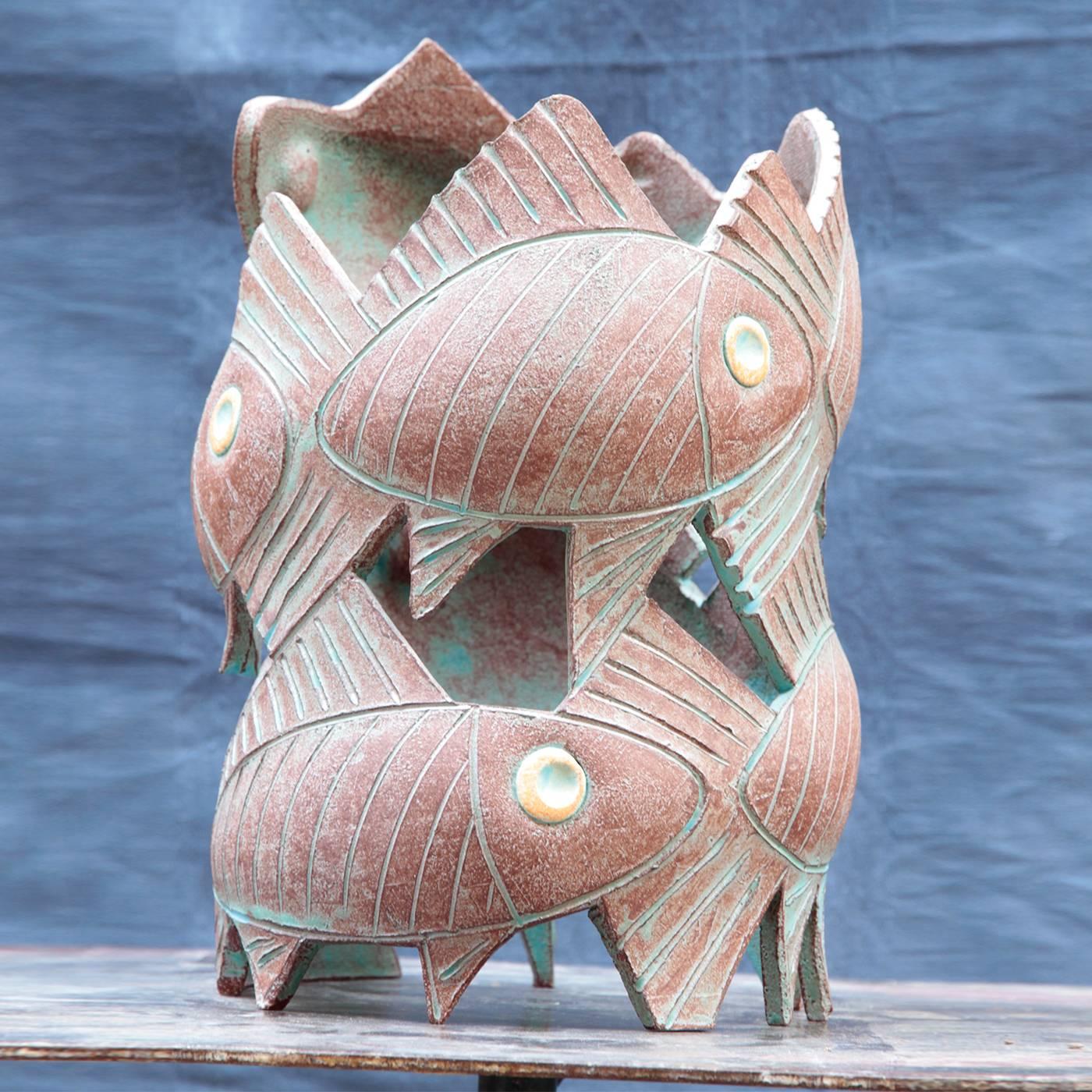 This exquisite ceramic sculpture is crafted using the technique called "a lastra", where the terracotta is initially molded around a temporary support. The piece is then cooked at 2190 degrees Fahrenheit and finished with cinder-based