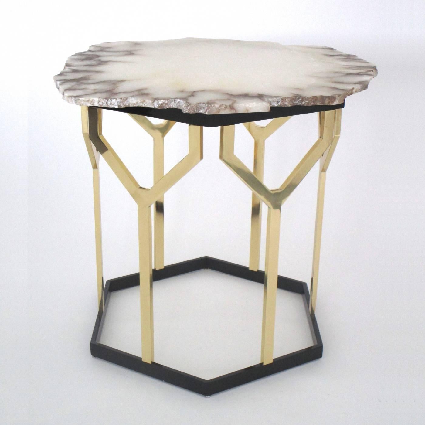 This elegant table features an hexagonal base in iron that supports a geometric structure in polished brass. The top is a slab in natural alabaster with irregular edges that make this a perfect accent piece with a modern appeal.