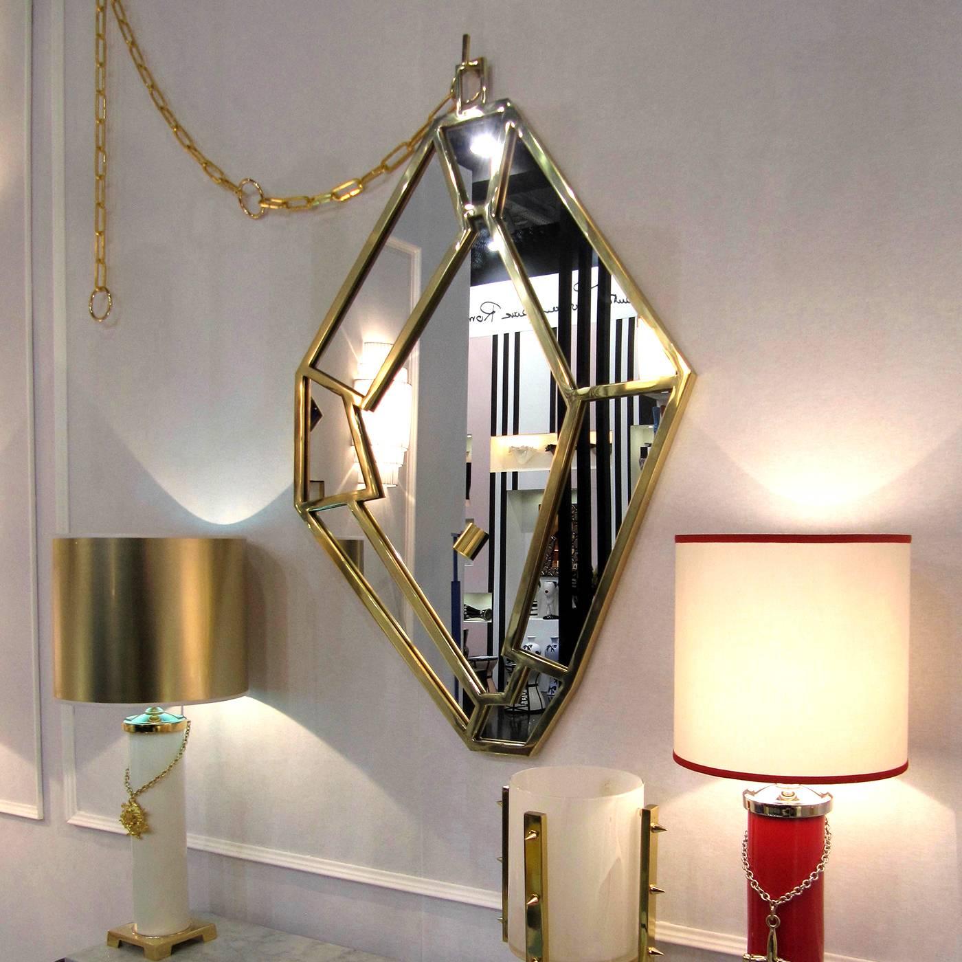 The irregular frame of this mirror is in brass that was entirely handmade and comprised of pieces welded by hand and brushed to obtain a polished finish. 